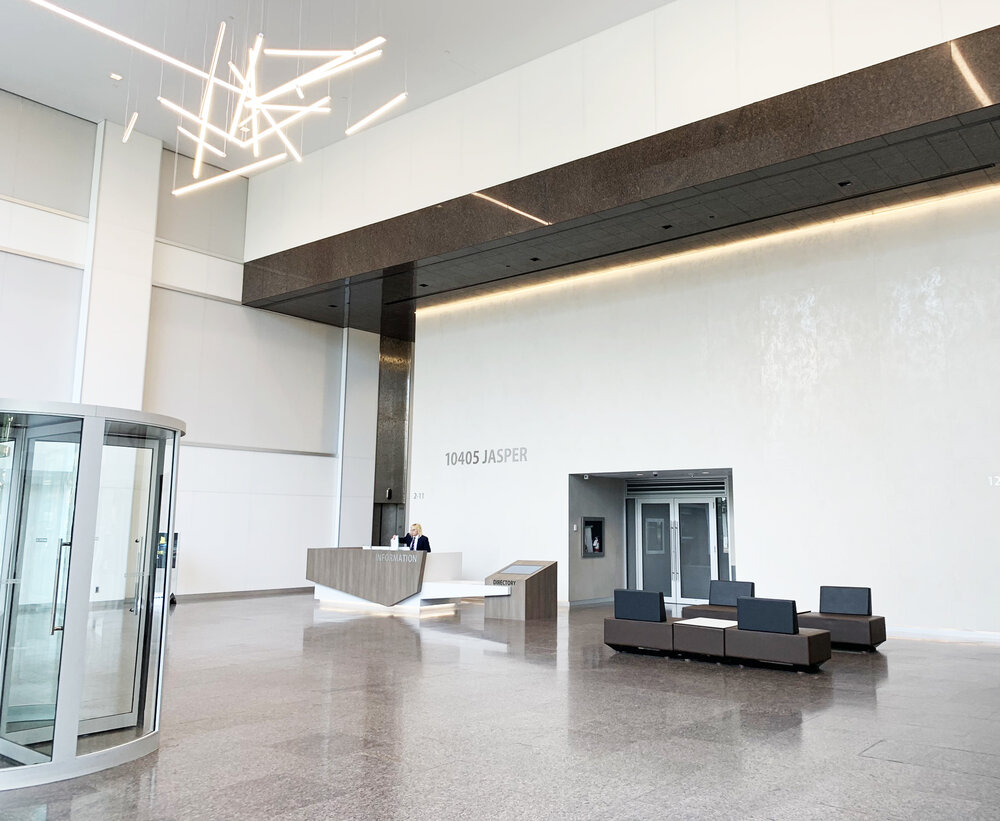 Bright lobby and reception area with seating and sculptural light fixture