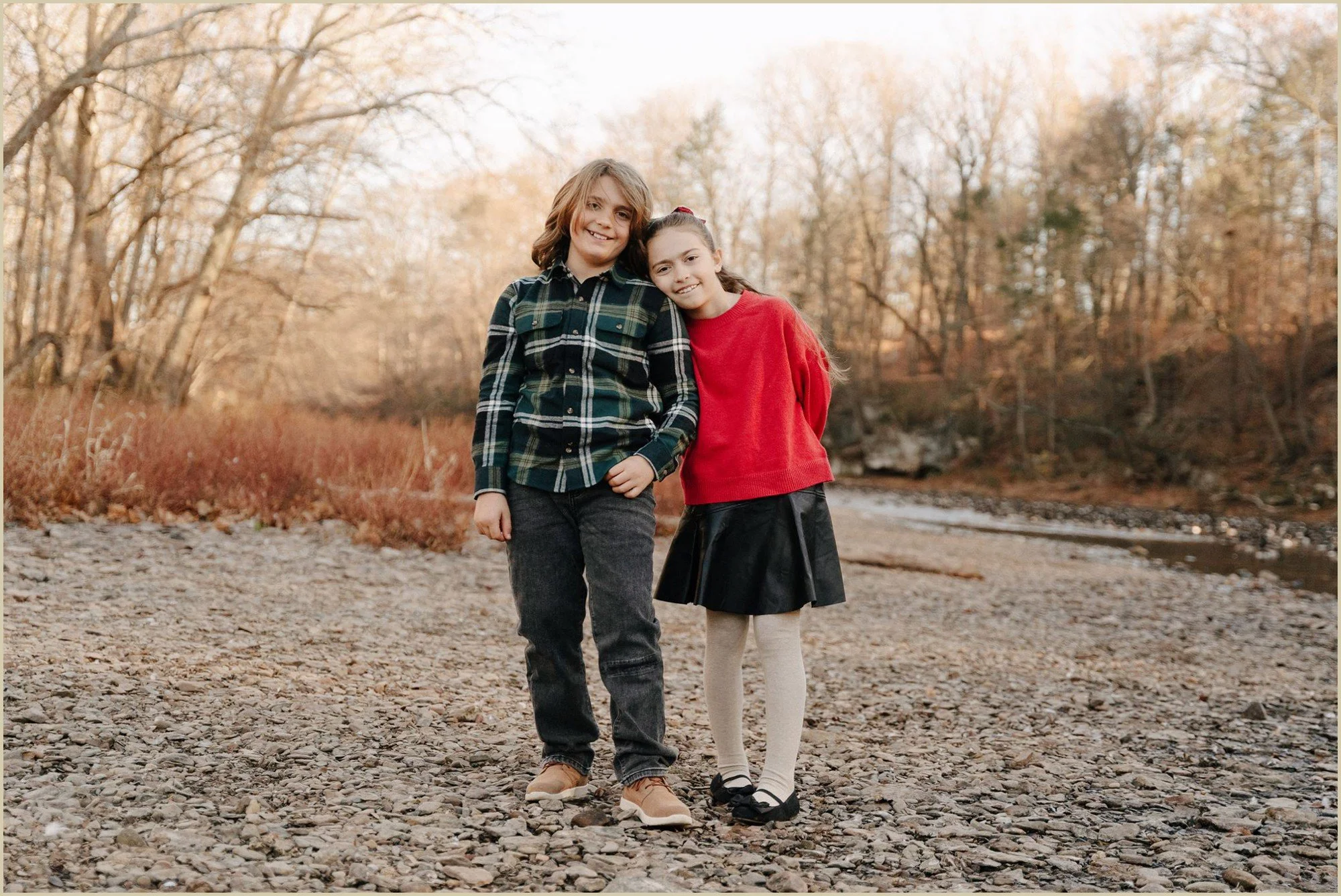 a brother and sister smiling causally at the camera