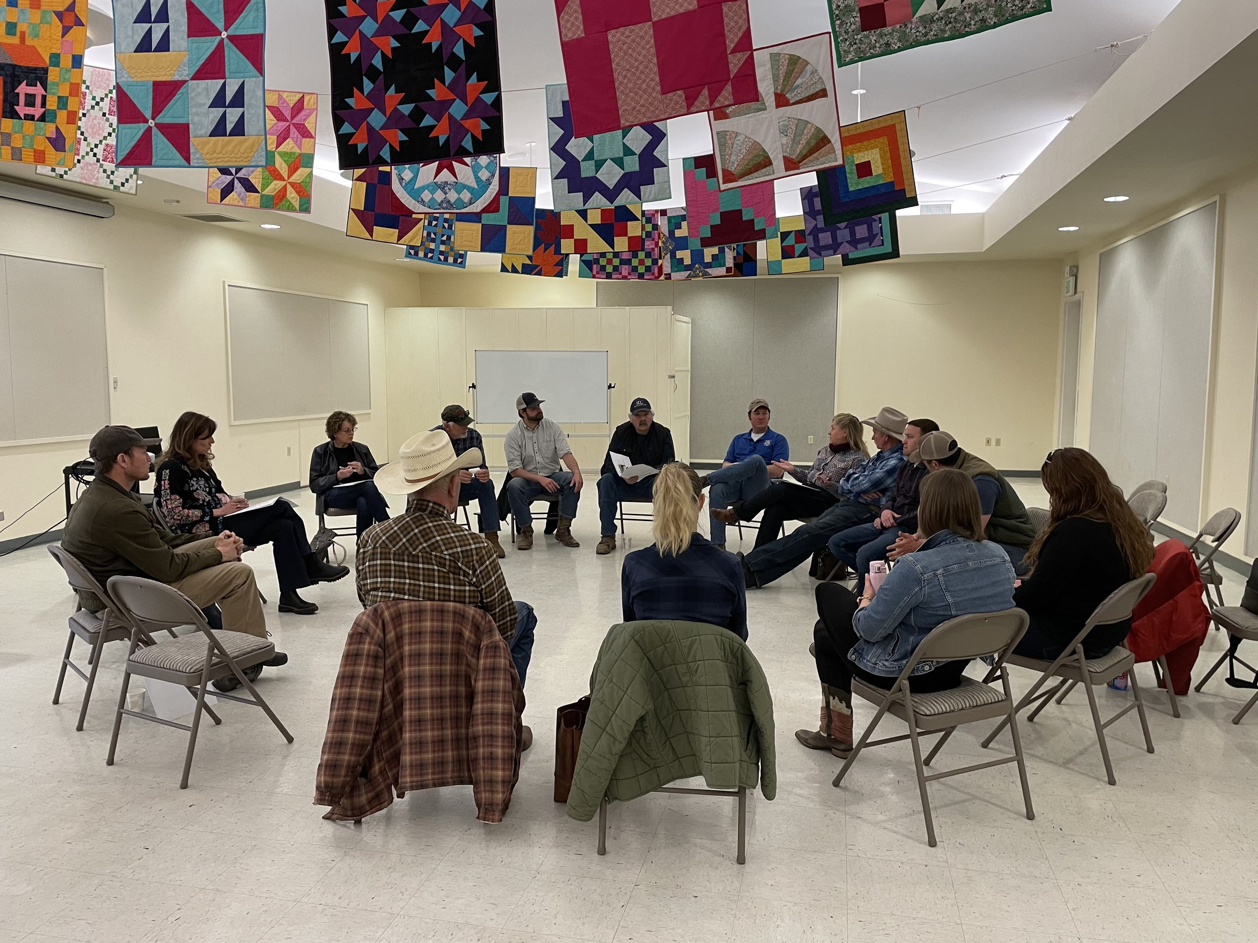 A group of Oregonians sit in a circle discussing rural Oregon needs.
