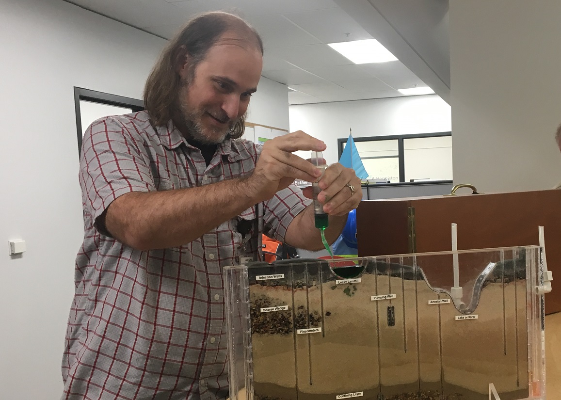  Tom Sicilia starts injecting green liquid to show how tank waste at Hanford can leak into the ground. 