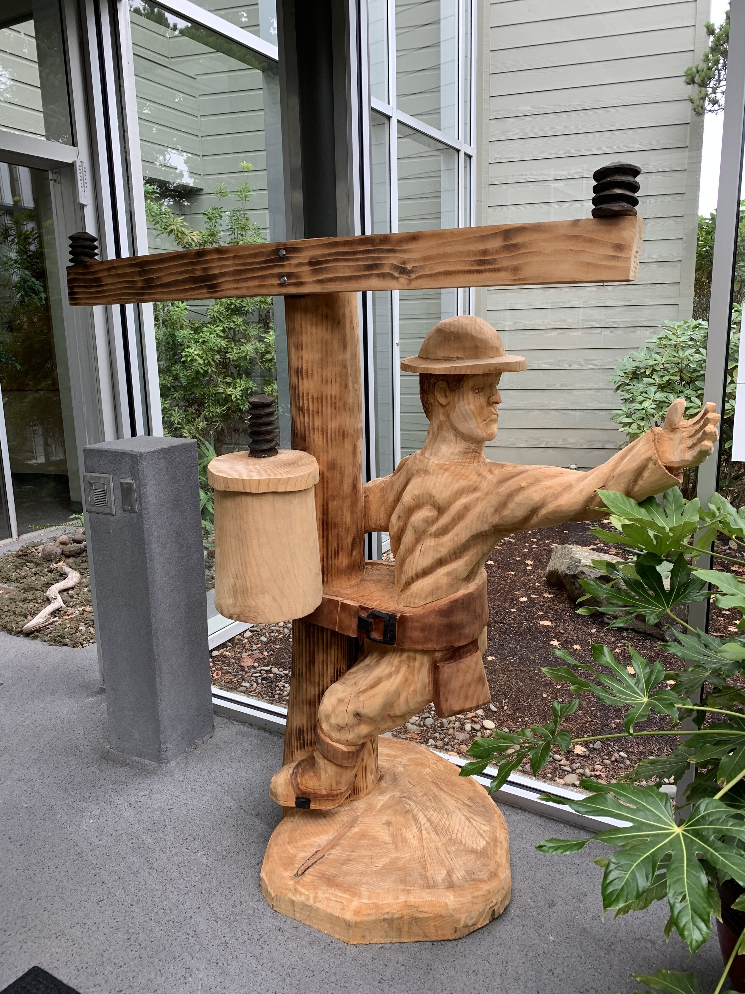 This line worker sculpture at Central Lincoln PUD was created by chainsaw artist Matt Holznagel