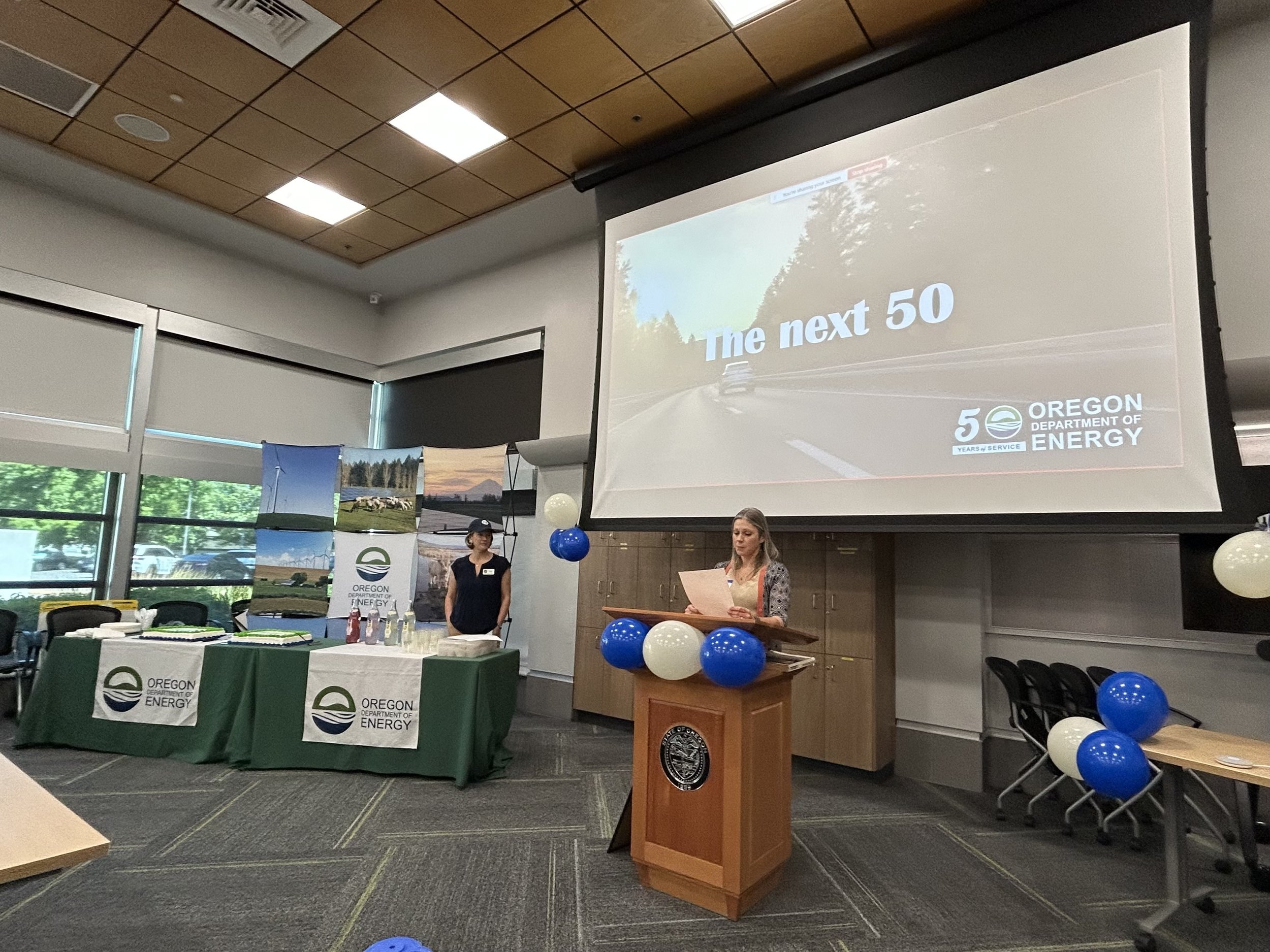 Governor Kotek's Climate and Energy Policy Advisor (and former ODOE team member), Amy Schlusser, reads a letter from the Governor to ODOE staff.