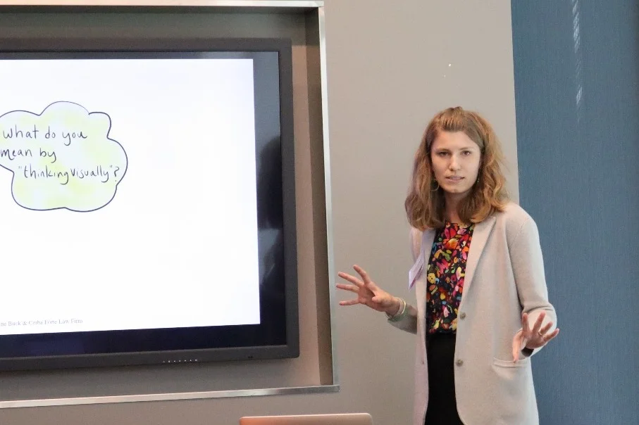 Maddy Buck speaking in front of a crowd at a workshop.