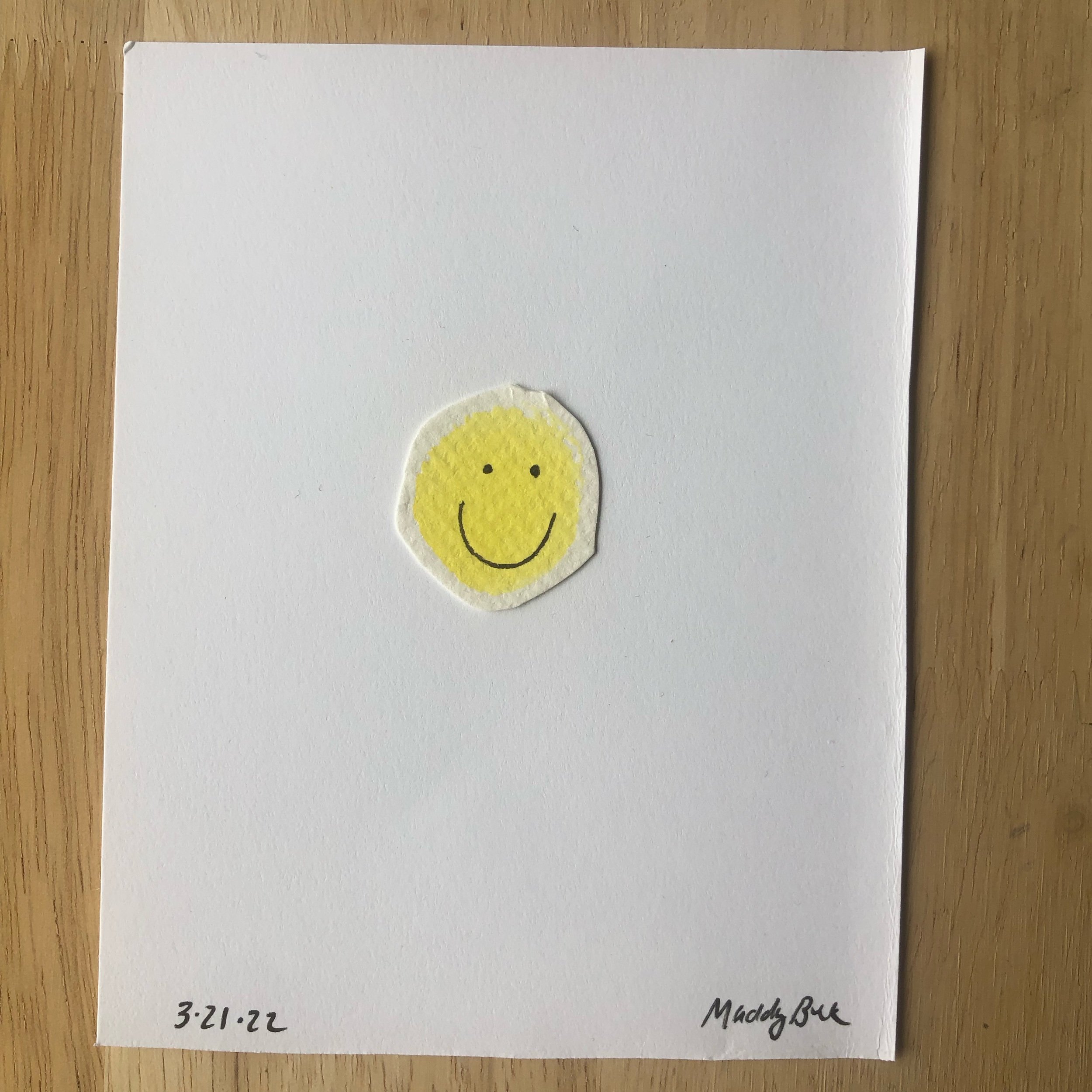  100 Day Project illustration that uses ink and yellow painted watercolor paper blob. Illustration shows a smiley.  