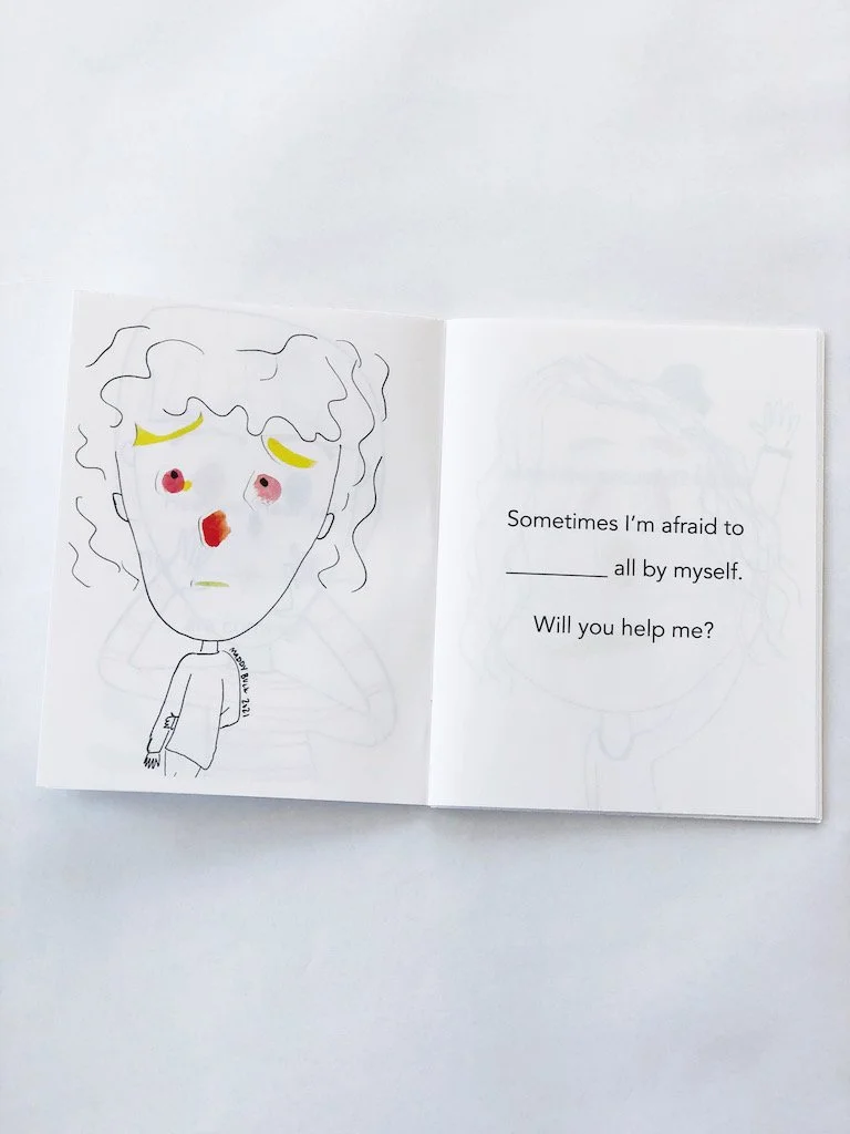  Photo of a picture book open to a page. On the left is a girl with a concerned-looking face. Her eyes, nose, eyebrows, and mouth are created with collage pieces, blobs of watercolor paper that have been painted. On the right page is a sentence that 