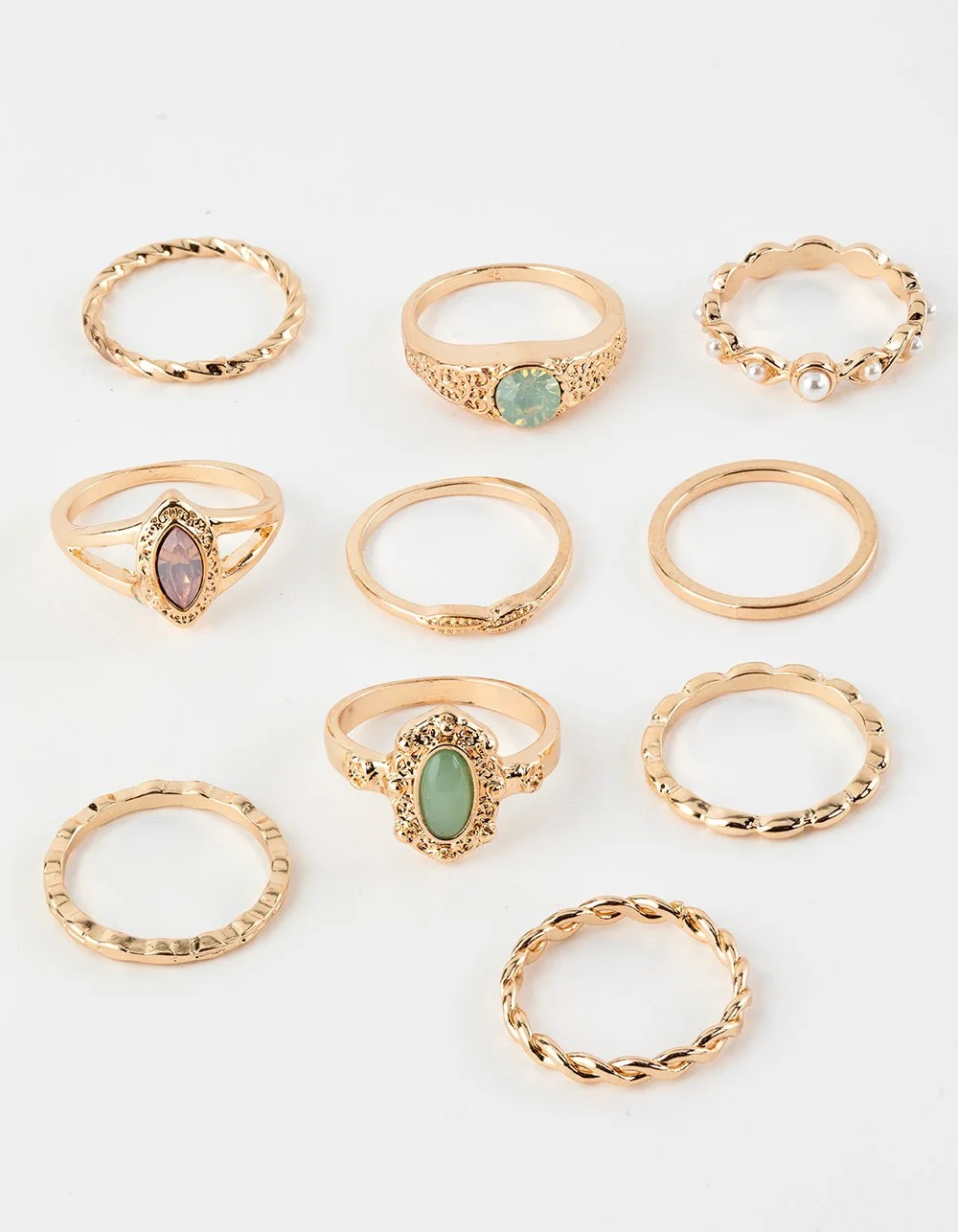 Collection of twelve gold and rose gold rings with various designs and gemstones, arranged in three rows on a white background.
