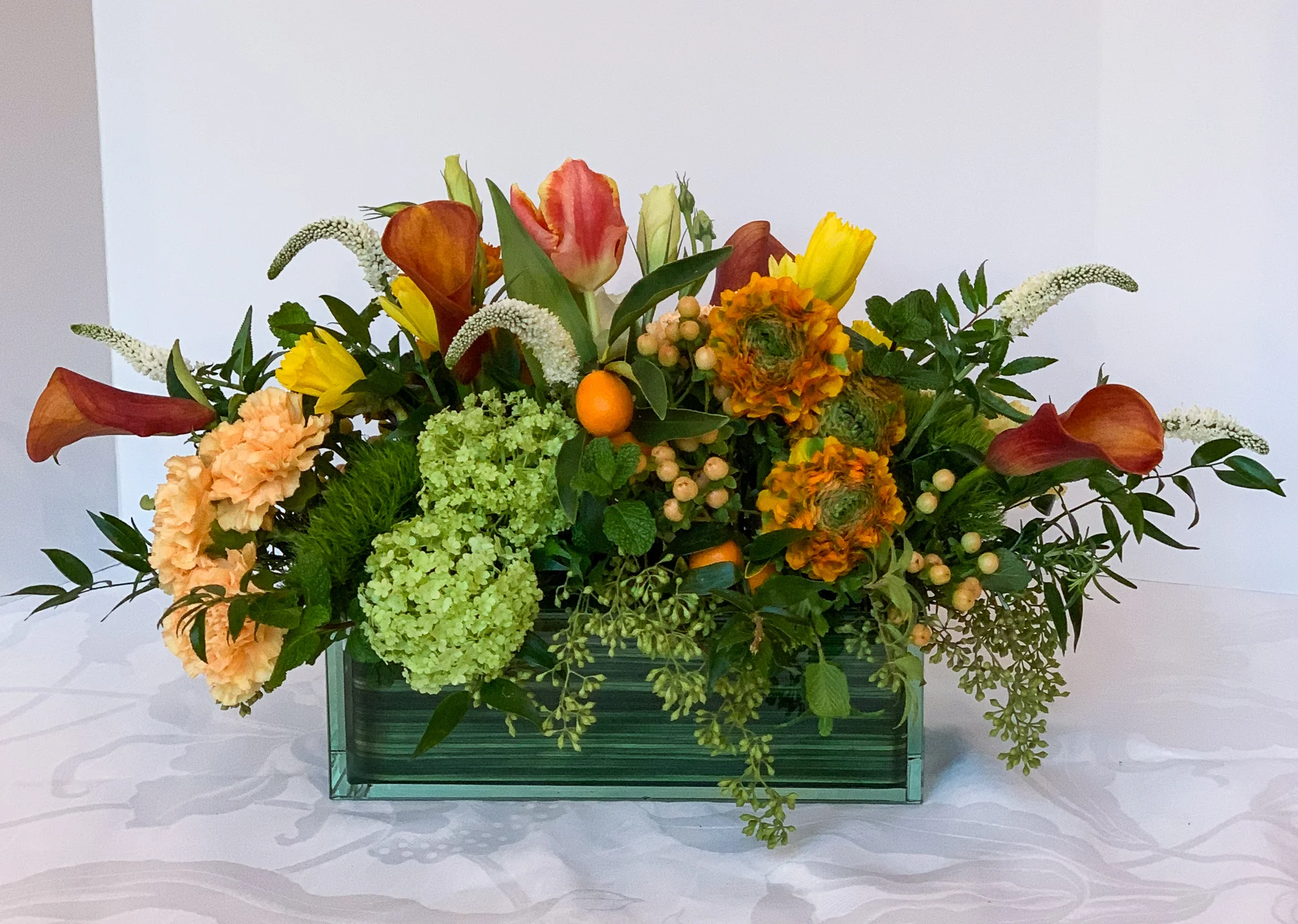 Calla Hybrid, Italian Ruscus, Veronica, Carnation, Daffodil, Green Trick, Vibernum, Seeded Eucalyptus, Kumquat, Tulip , Hypericum, Ranunculus
