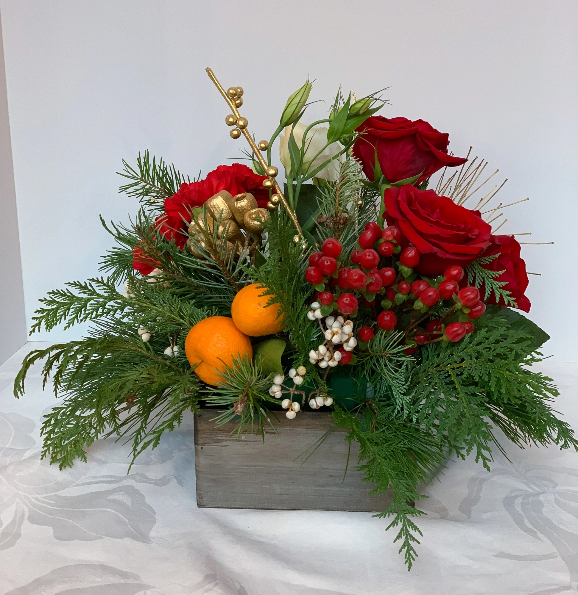 Mandarin Oranges, Roses, Red Hypericum, Winterberry, Painted Ilex Berry and Eucalyptus Seeds, Lisianthus, Cedar, Christmas Greens