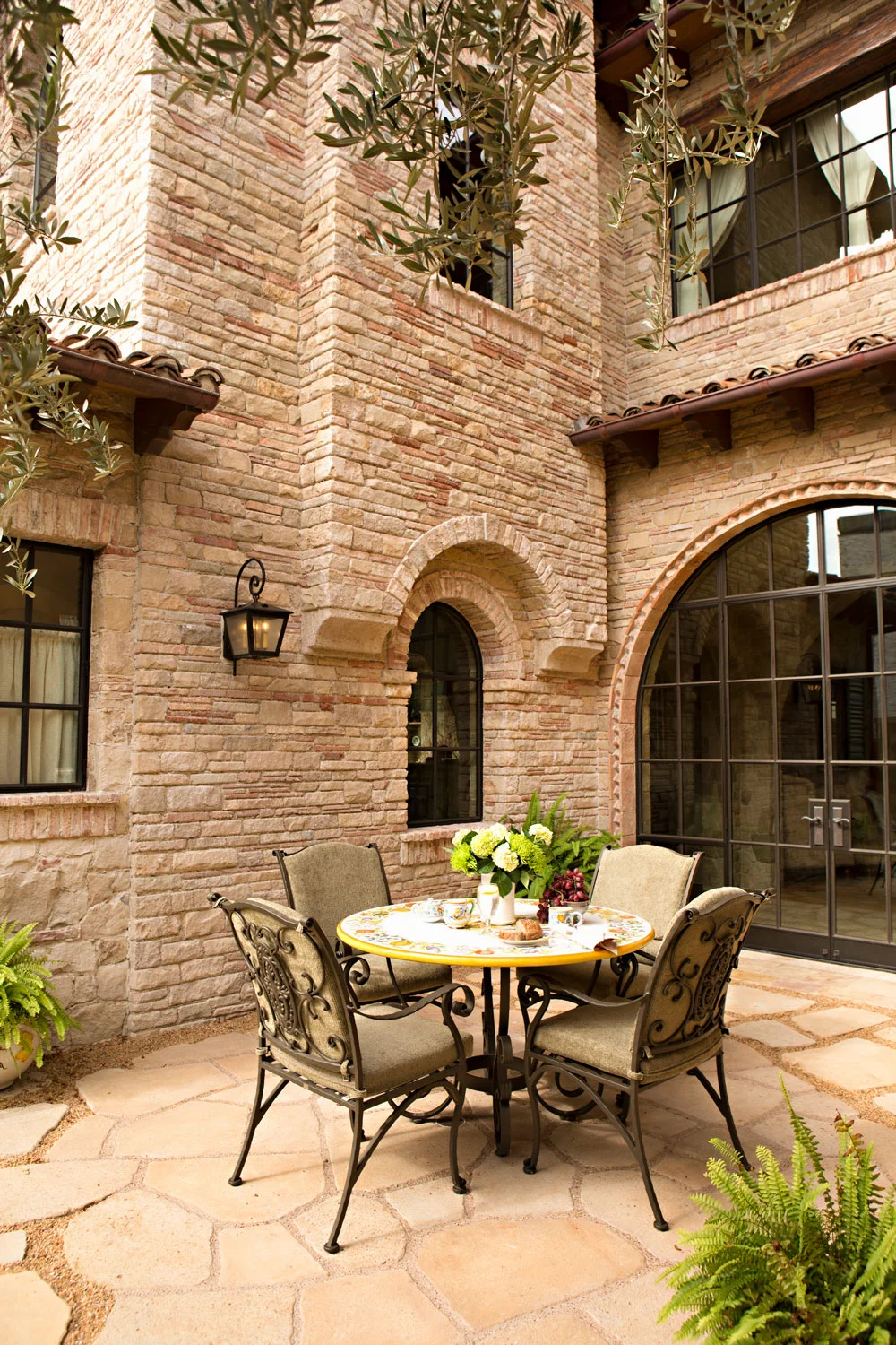 Tuscan-Mediterranean-House-Exterior-Courtyard-Patio-Table-Stone-corbin-reeves.jpg