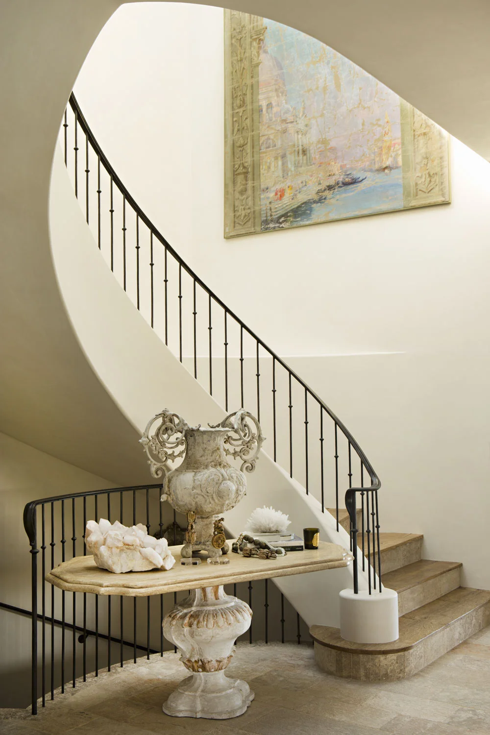 curved-staircase-wrought-iron-rail-landing-corbin-reeves.jpg