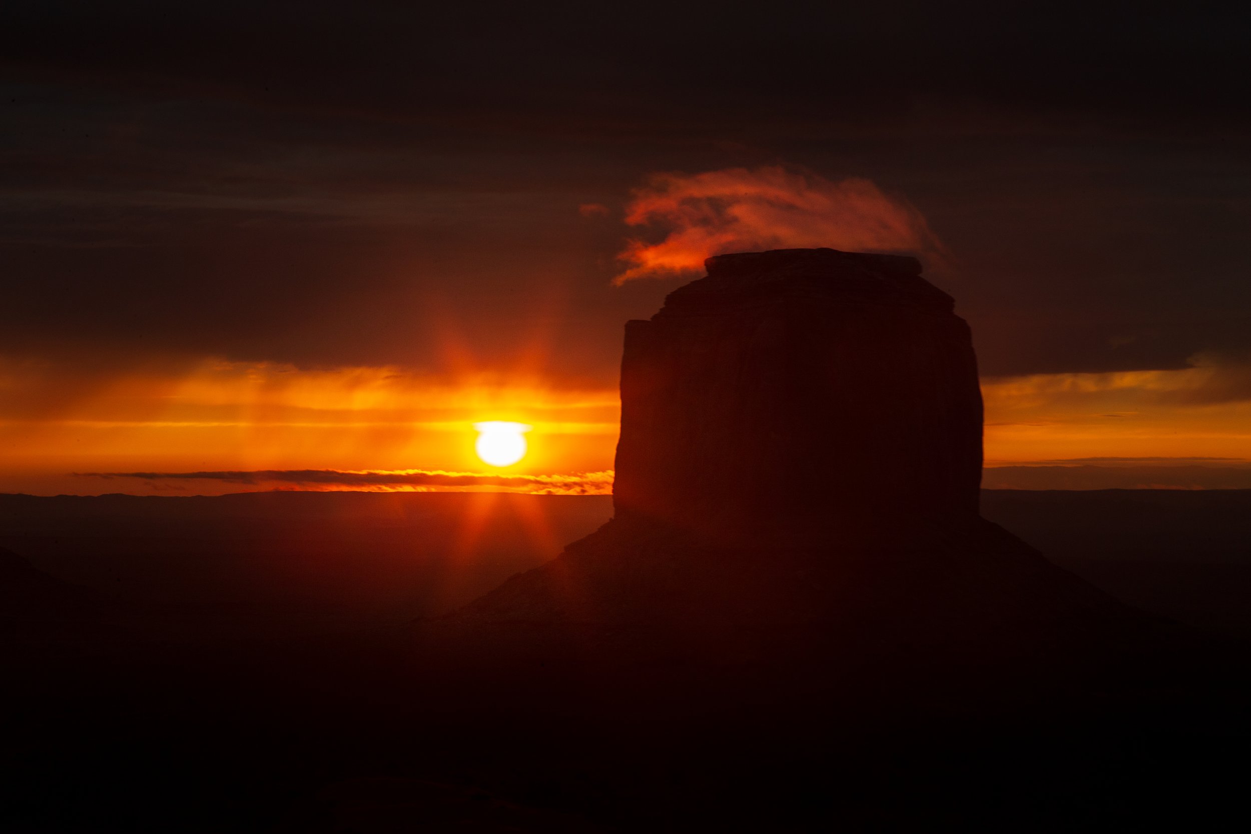  Clouds slowly dissipate as the first light finally touches Merrick Butte and Monument Valley 