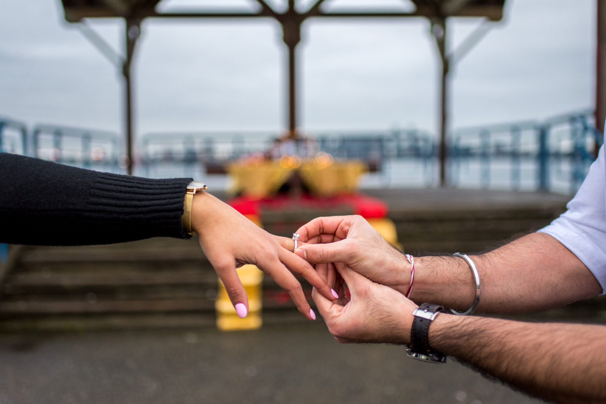 Engagement ring is put on a finger in North Vancouver BC