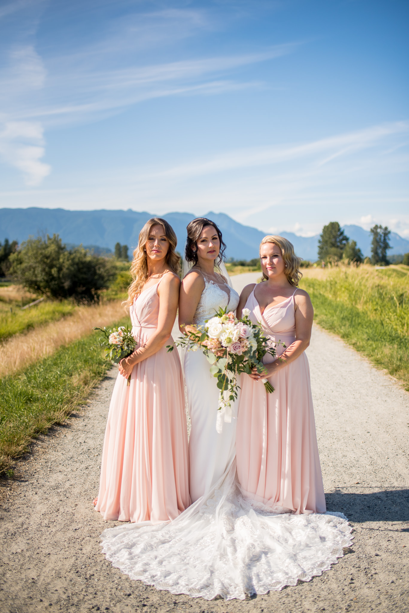 Bride and her bridesmaids standing in front of mountains in BC Canada