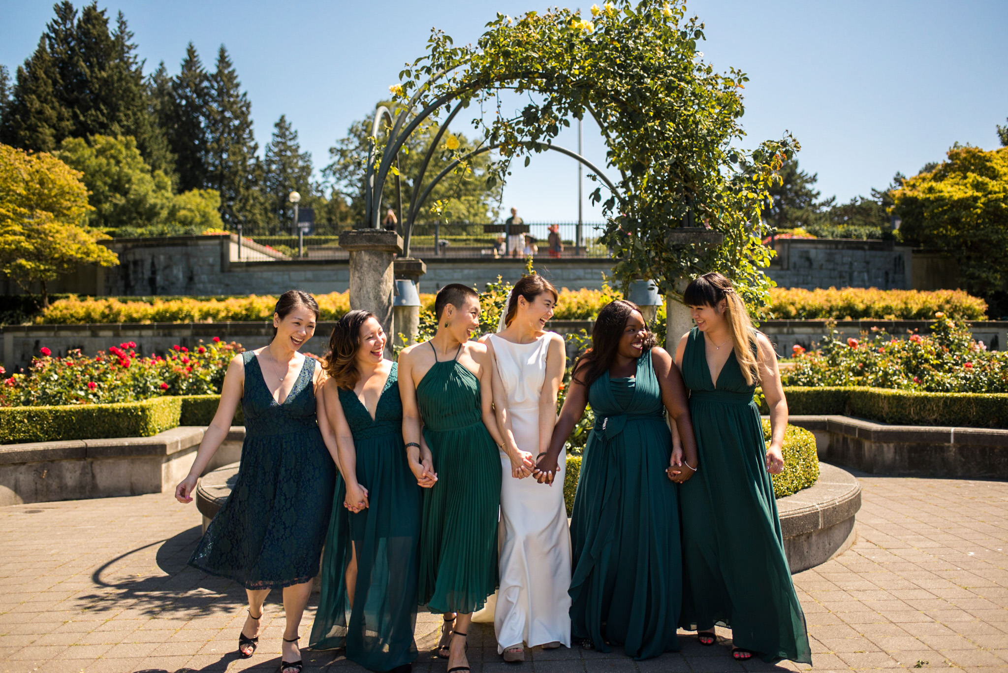 Bride and Bridesmaids sharing a laugh at UBC Rose Garden in Vancouver B.C.