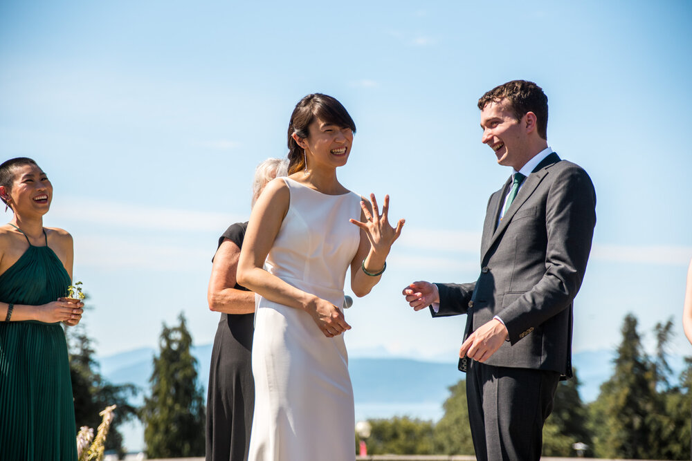 Bride shows off wedding ring during wedding ceremony at UBC Rose Garden in Vancouver B.C.