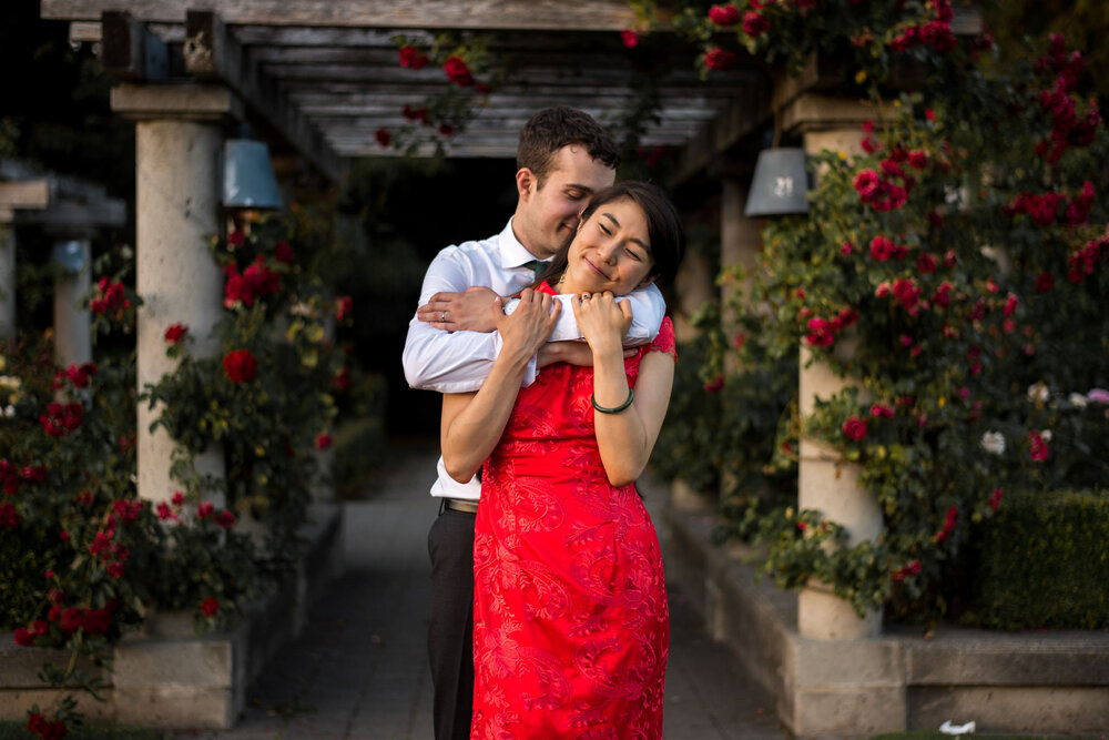 Bride and groom cuddling at UBC Rose Garden in Vancouver B.C.