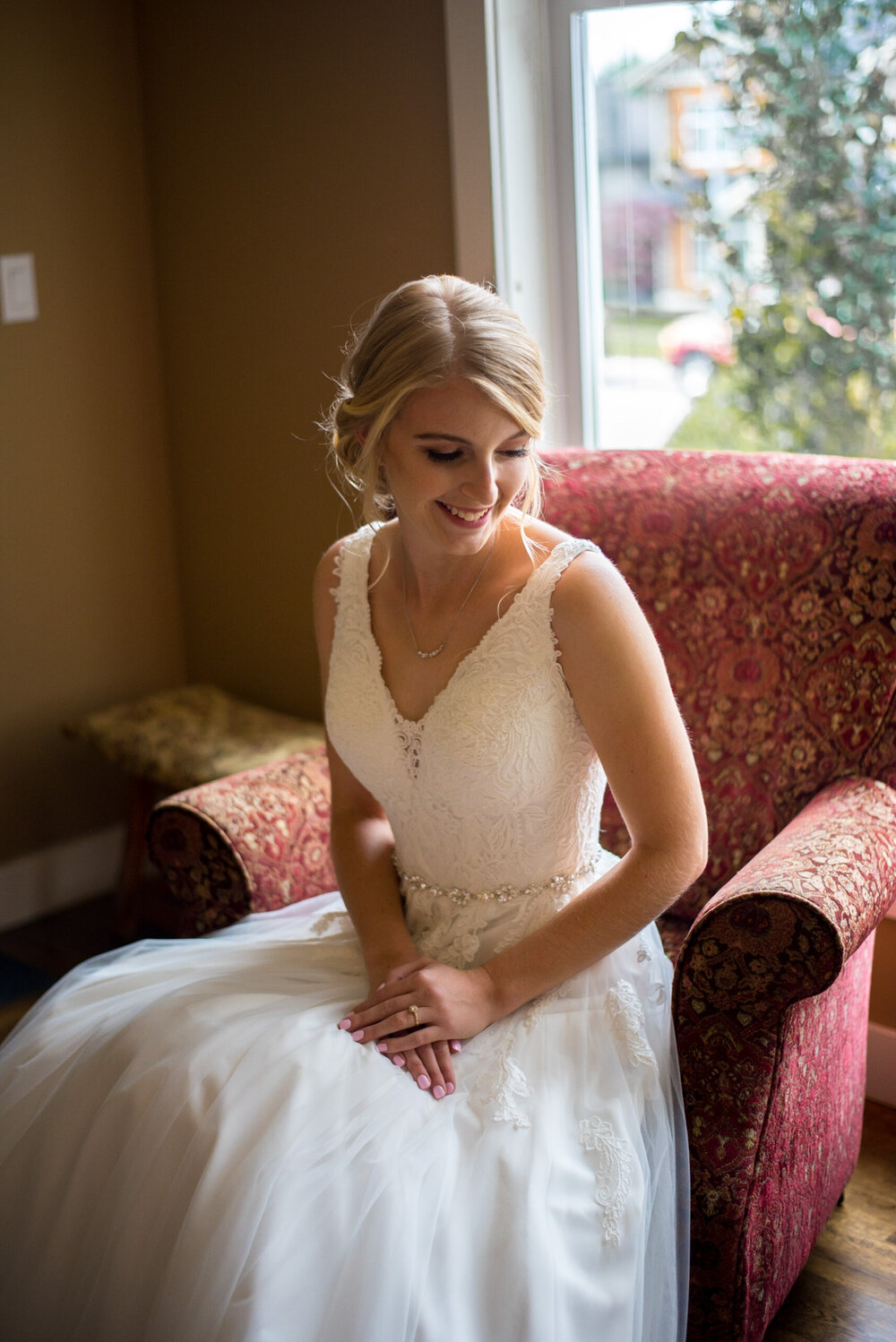 Bride sitting in a chair in her wedding dress in New Westminster, B.C.