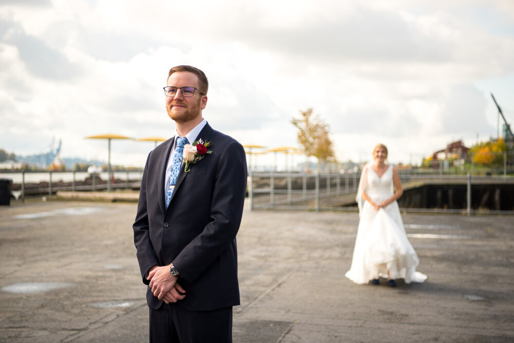 Groom waits for the bride during their first look at Pier Park in New Westminster, B.C.