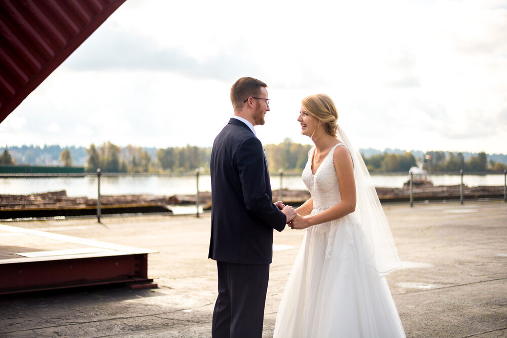 Bride laughs during first look at Pier Park in New Westminster, B.C.