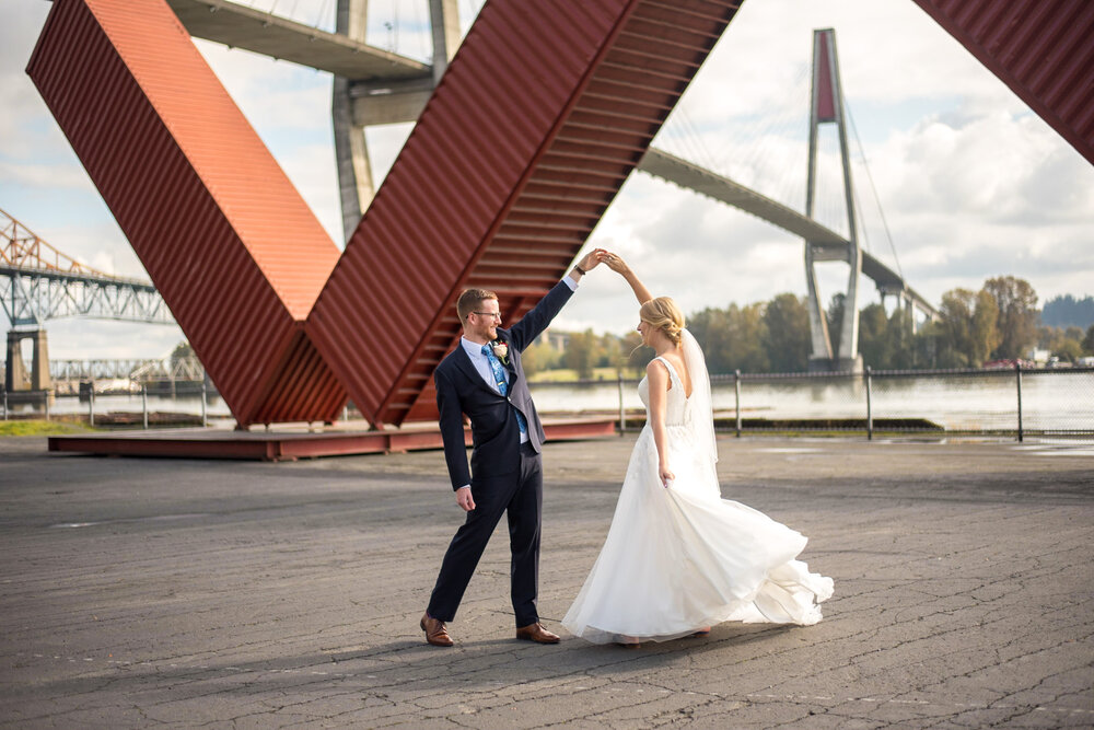 Bride and groom dancing in front of Patullo Bridge in New Westminster, B.C.