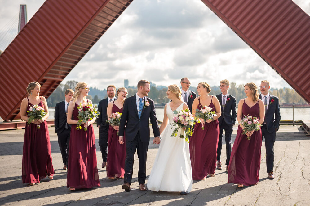 Wedding party laughing together during a walk at Pier Park in New Westminster, B.C.