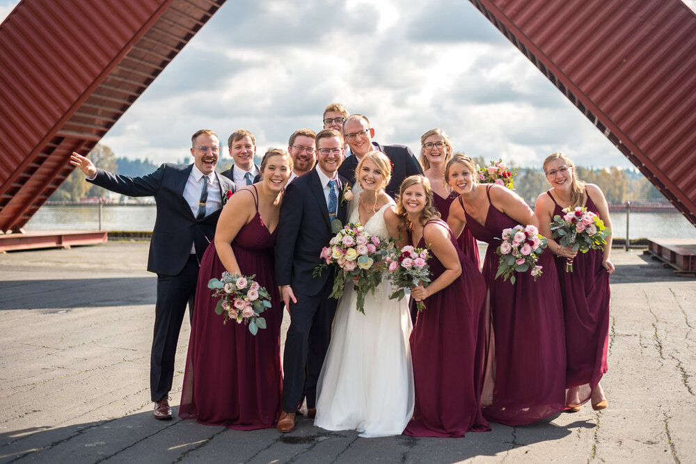 Wedding party poses for a fun photo in Pier Park at New Westminster B.C.