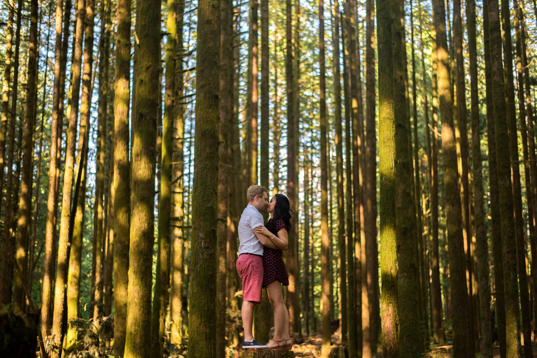 An engaged couple standing in the forest of Golden Ears Provincial Park in Maple Ridge, B.C.