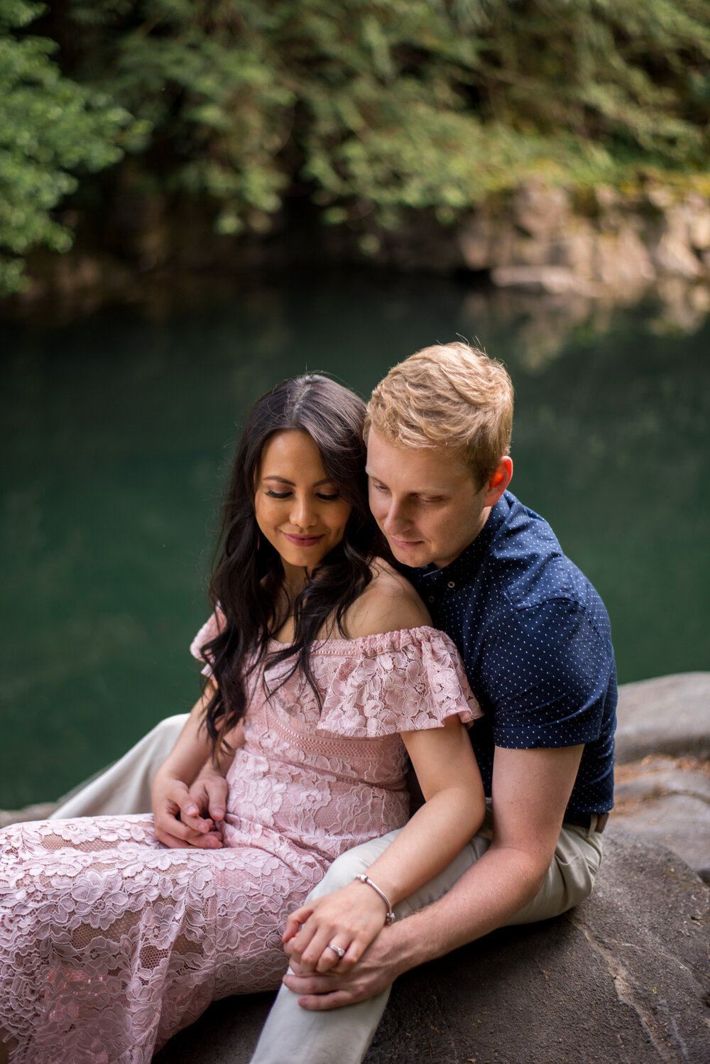 A couple cuddling by Gold Creek at Golden Ears Provincial Park in Maple Ridge, B.C.