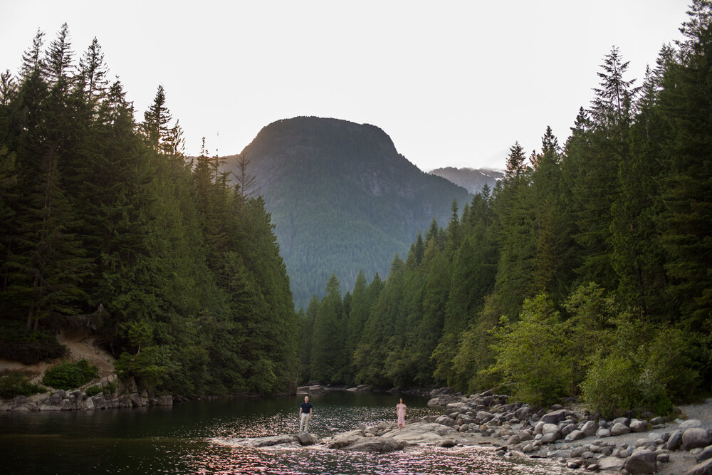 A couple standing far apart at North Beach in Golden Ears Provincial Park at Maple Ridge, B.C.