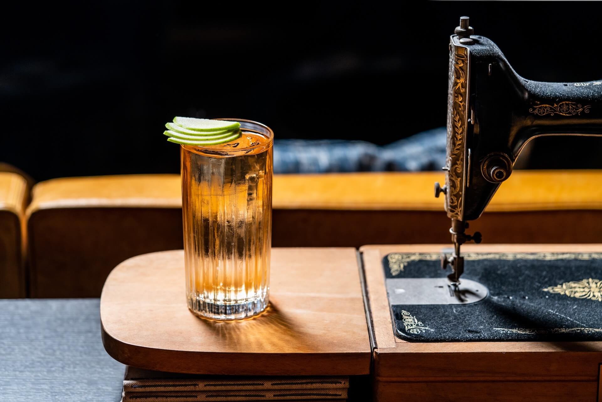 Anantara_Grand_Hotel_Krasnapolsky_Amsterdam_Bar_The_Tailor_long_glass_cocktail_and_sewing_machine.jpeg