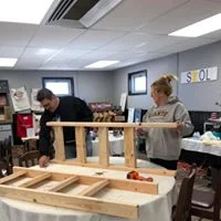 A couple works together to put a project together.