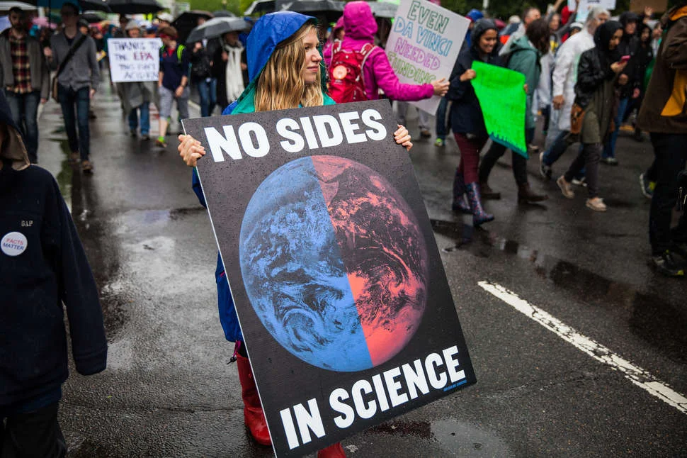 A woman holding a poster during the “March for Science" (original source)