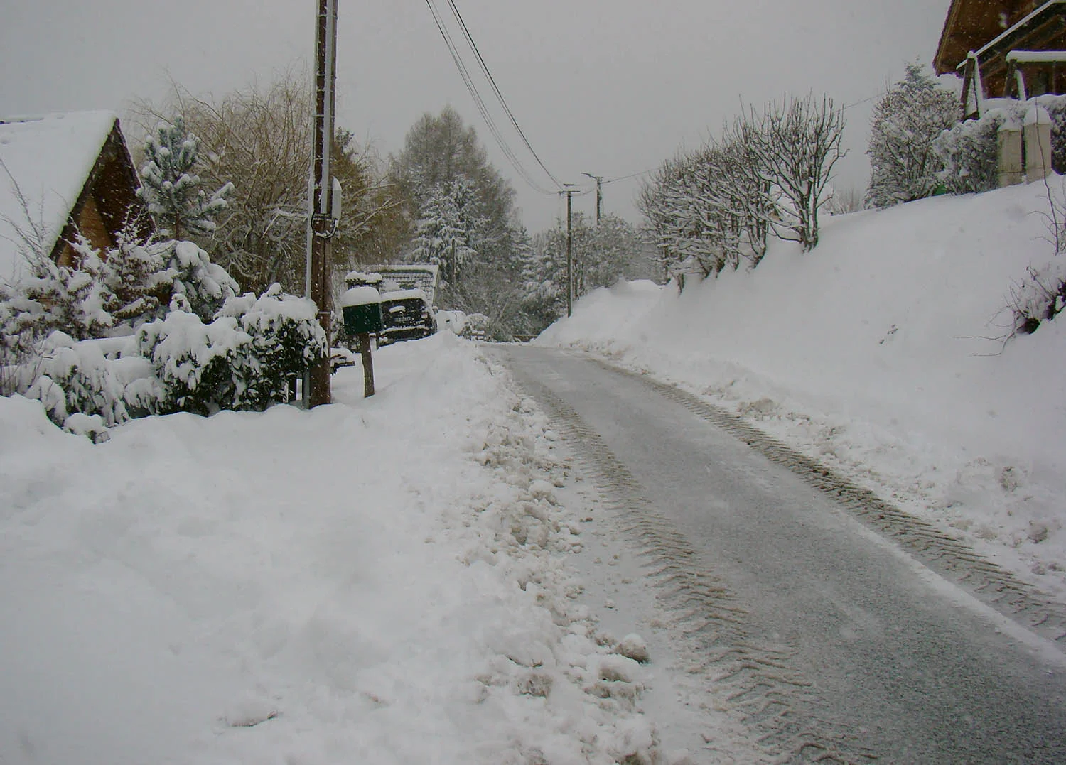 The snowplough had just been, but already snow was building on the road outside our chalet.