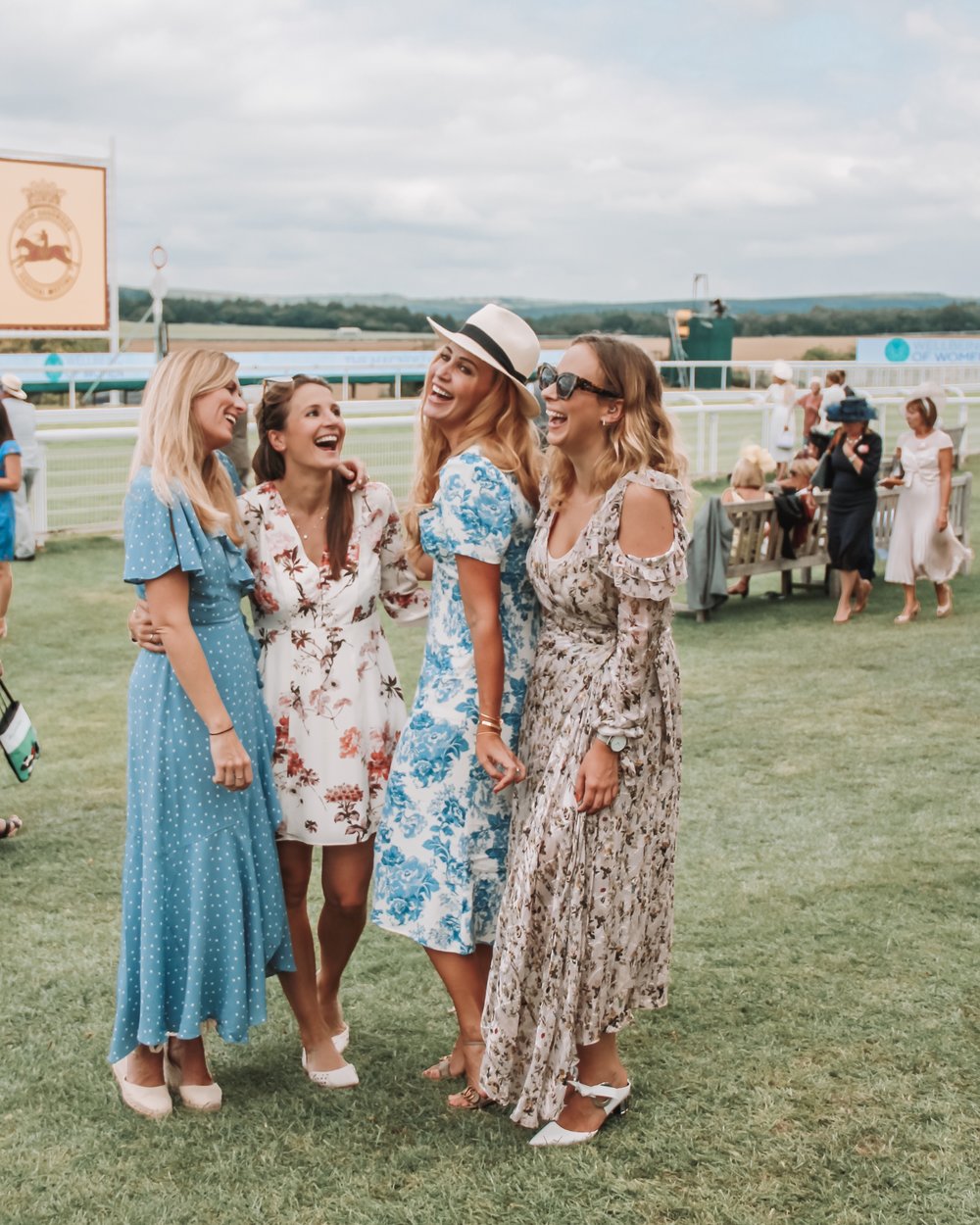Cat, Cath, me and Lucy in floral frocks in the Richmond Enclosure for Ladies Day at the Goodwood Festival 2019