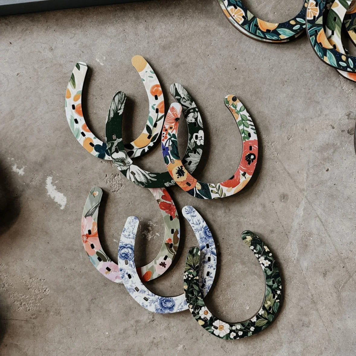 set of six wooden horseshoes with patterns printed on them