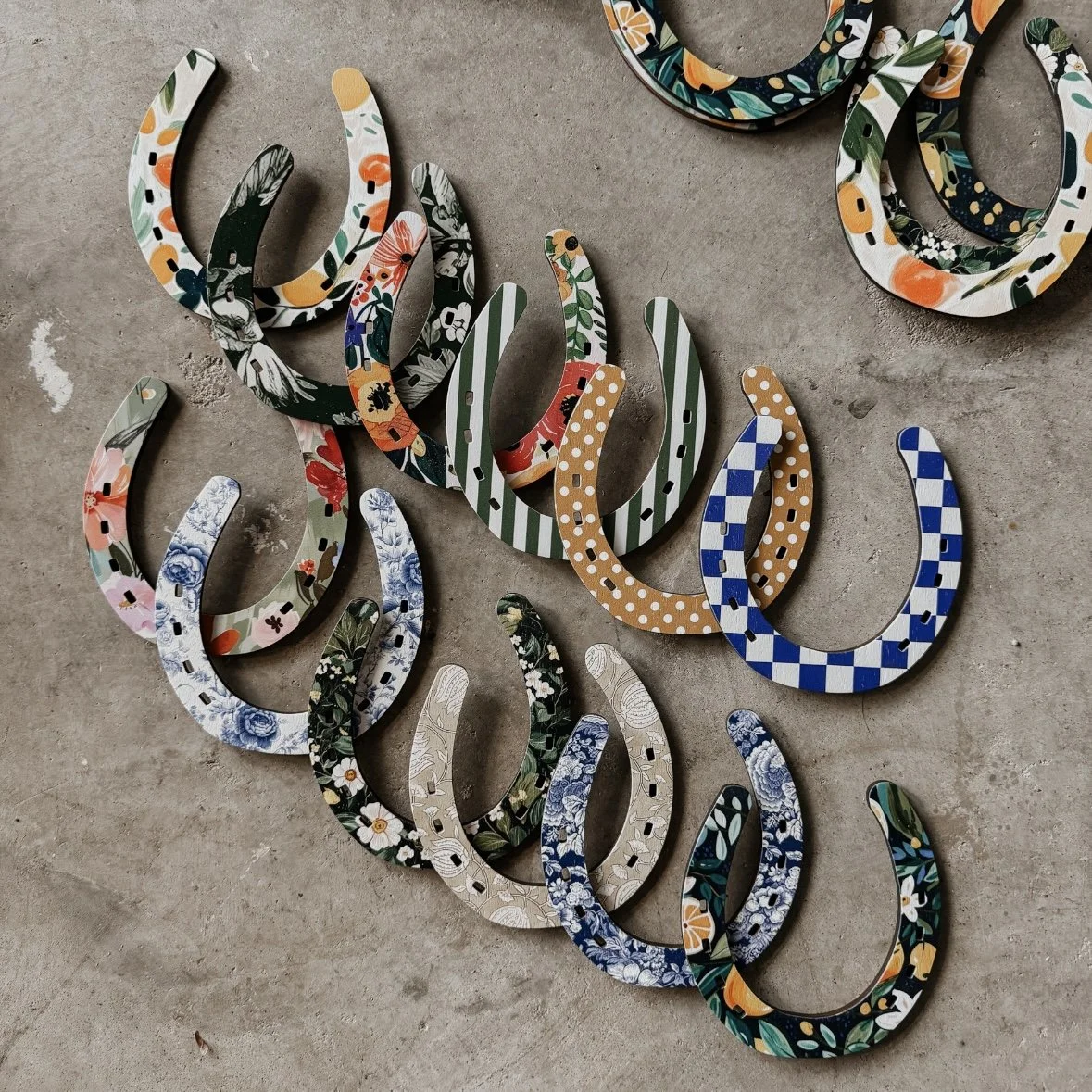 set of twelve wooden horseshoes with patterns printed on them