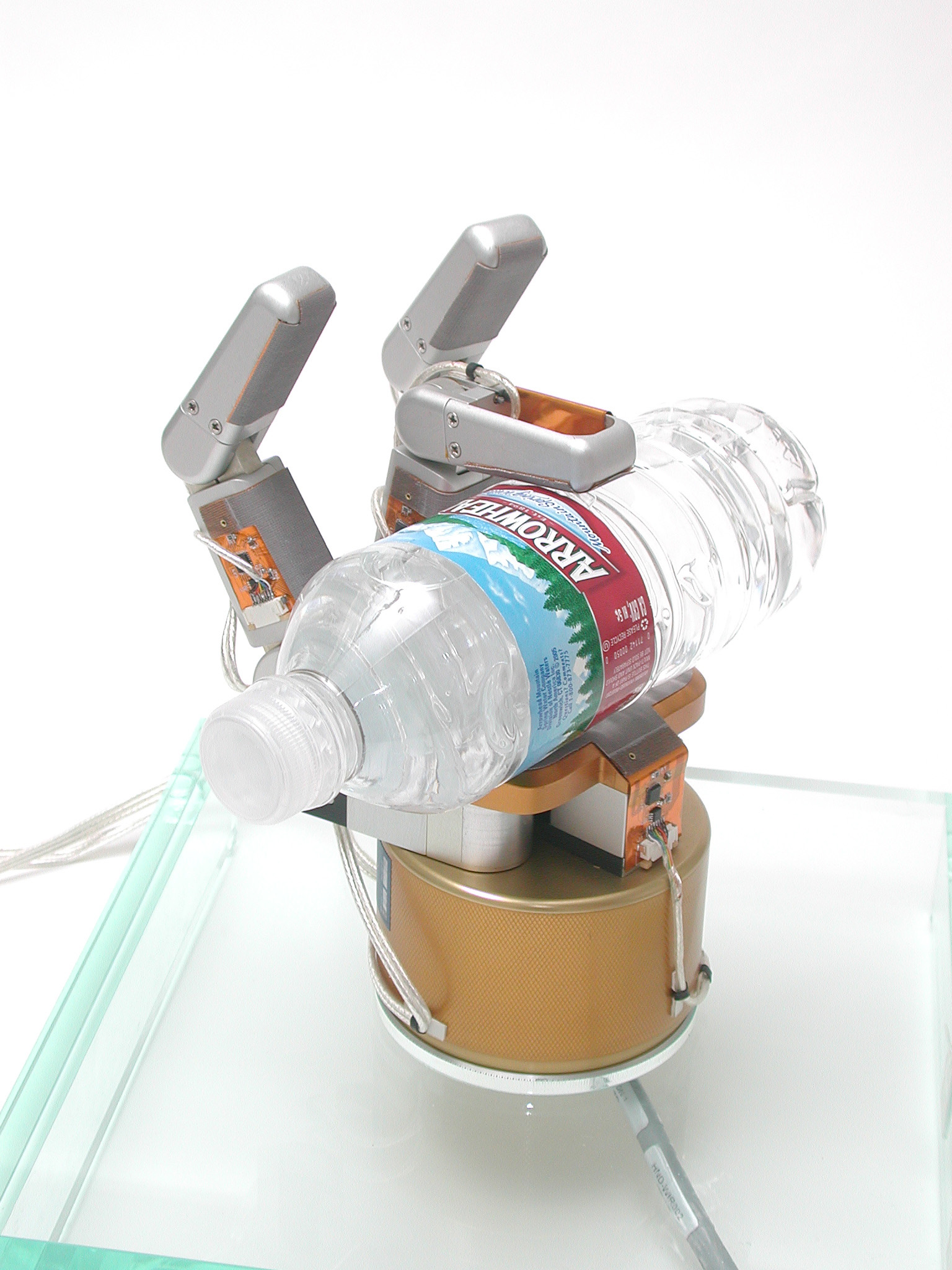 Robotic arm with tactile sensors holding a plastic bottle