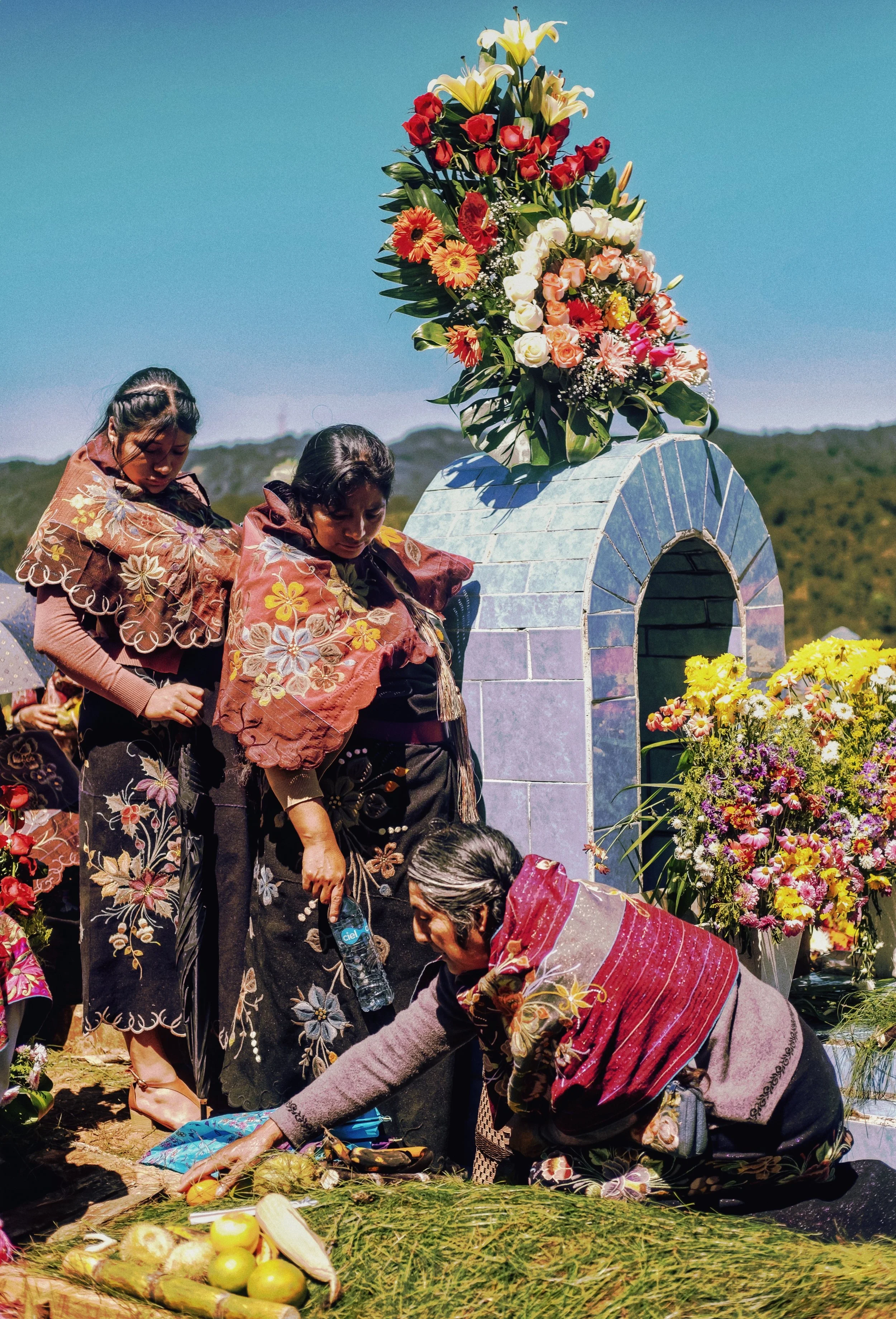 Women decorating tombstone on "Dia de los muertos", Day of the dead-San Cristobal de las casas