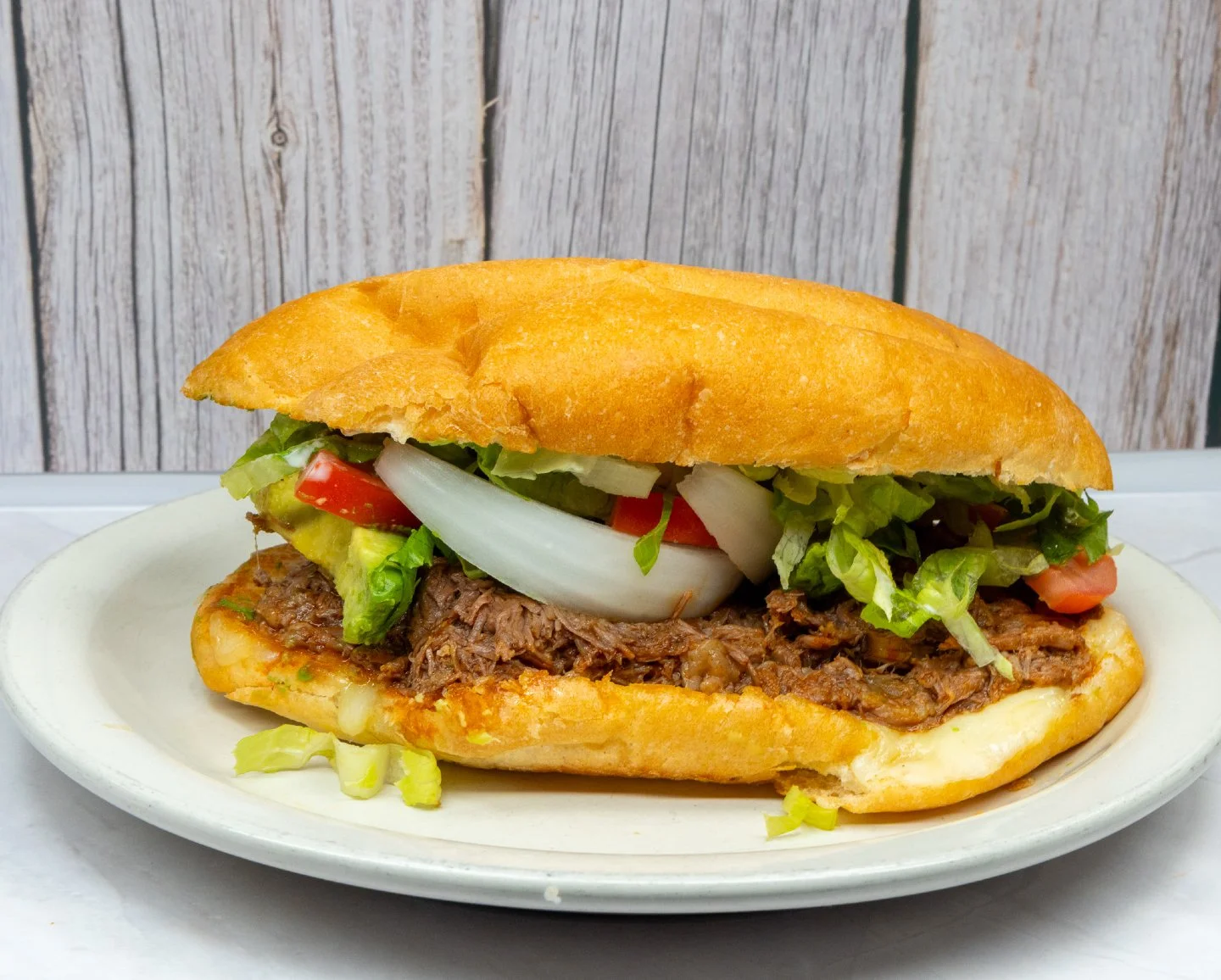 Did you know we serve traditional tortas?
A toasted Mexican-style bun packed with your choice of meat and topped with lettuce, tomatoes, avocado, onion, jalape&ntilde;os, and sour cream.
