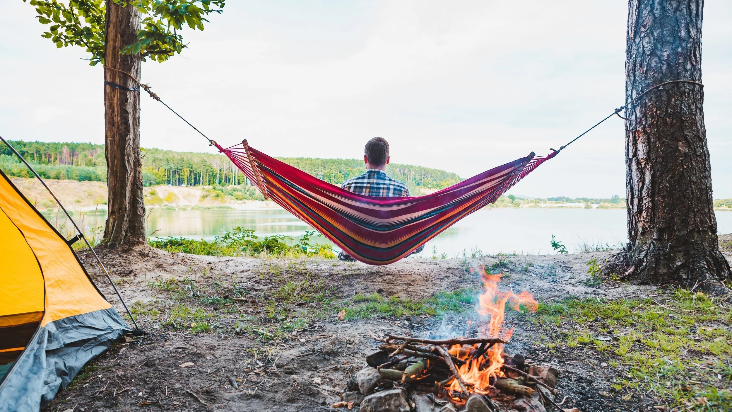 Hammock by Lake with Campfire - AdobeStock_367377426.jpg