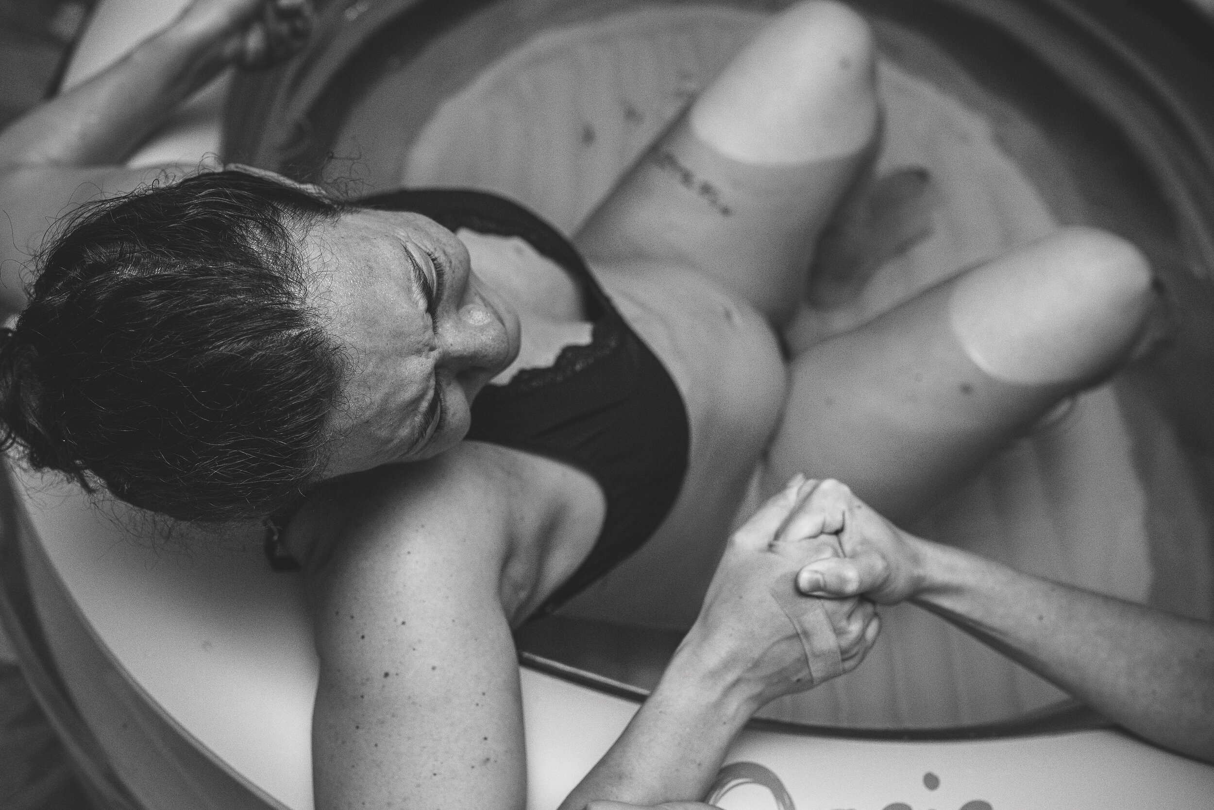 holding hands labor in tub.jpg