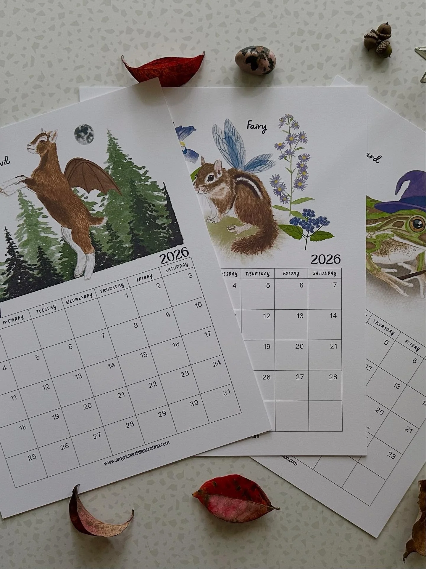 Happy October, Friends! 2026 calendars are now available along with a coordinating art print! Last summer, I started working on a series of monsters and cryptids, reimagined as whimsical animals. Think, black squirrel mothman and a sloth Sasquatch- a