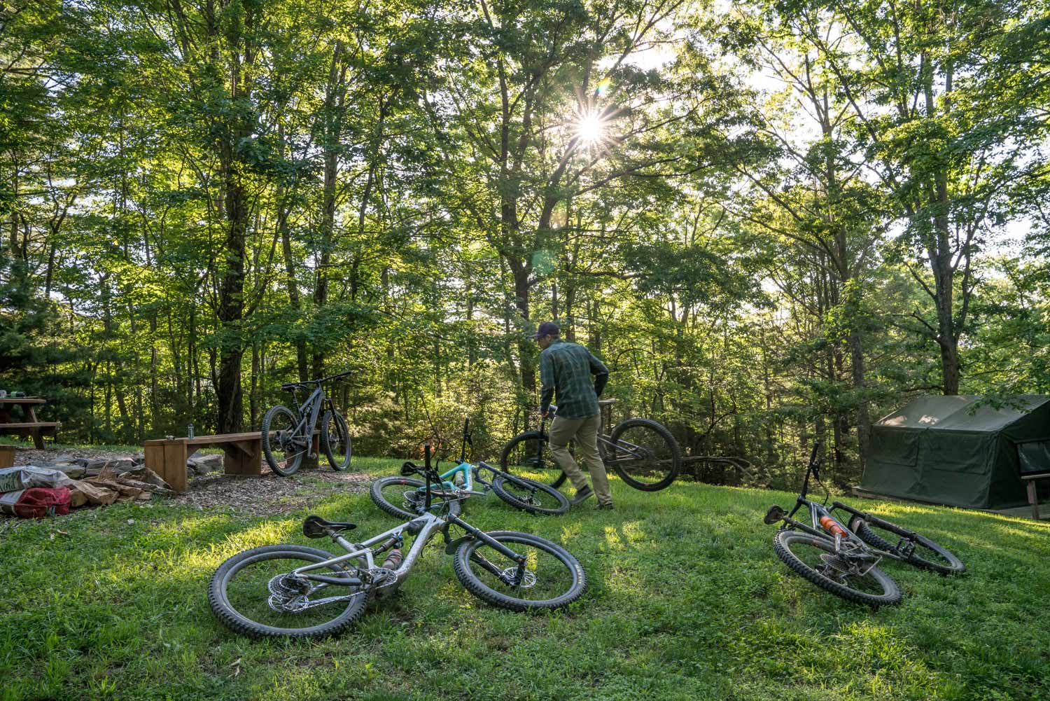 A man parking his mountain bike in the woods at the Bike Farm