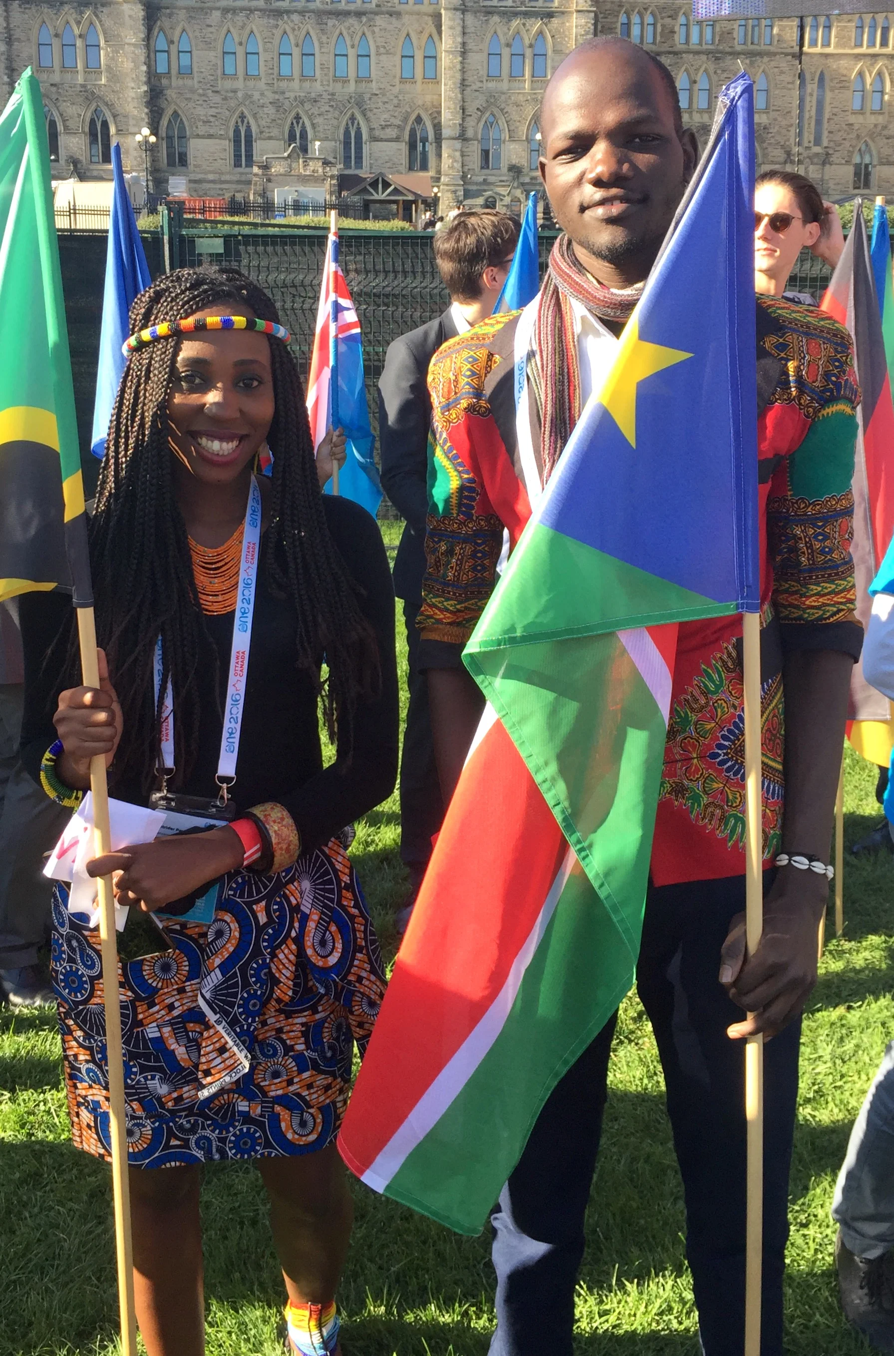 James holding the South Sudanese flag at the One Young World Summit in Ottawa, Canada, 2016