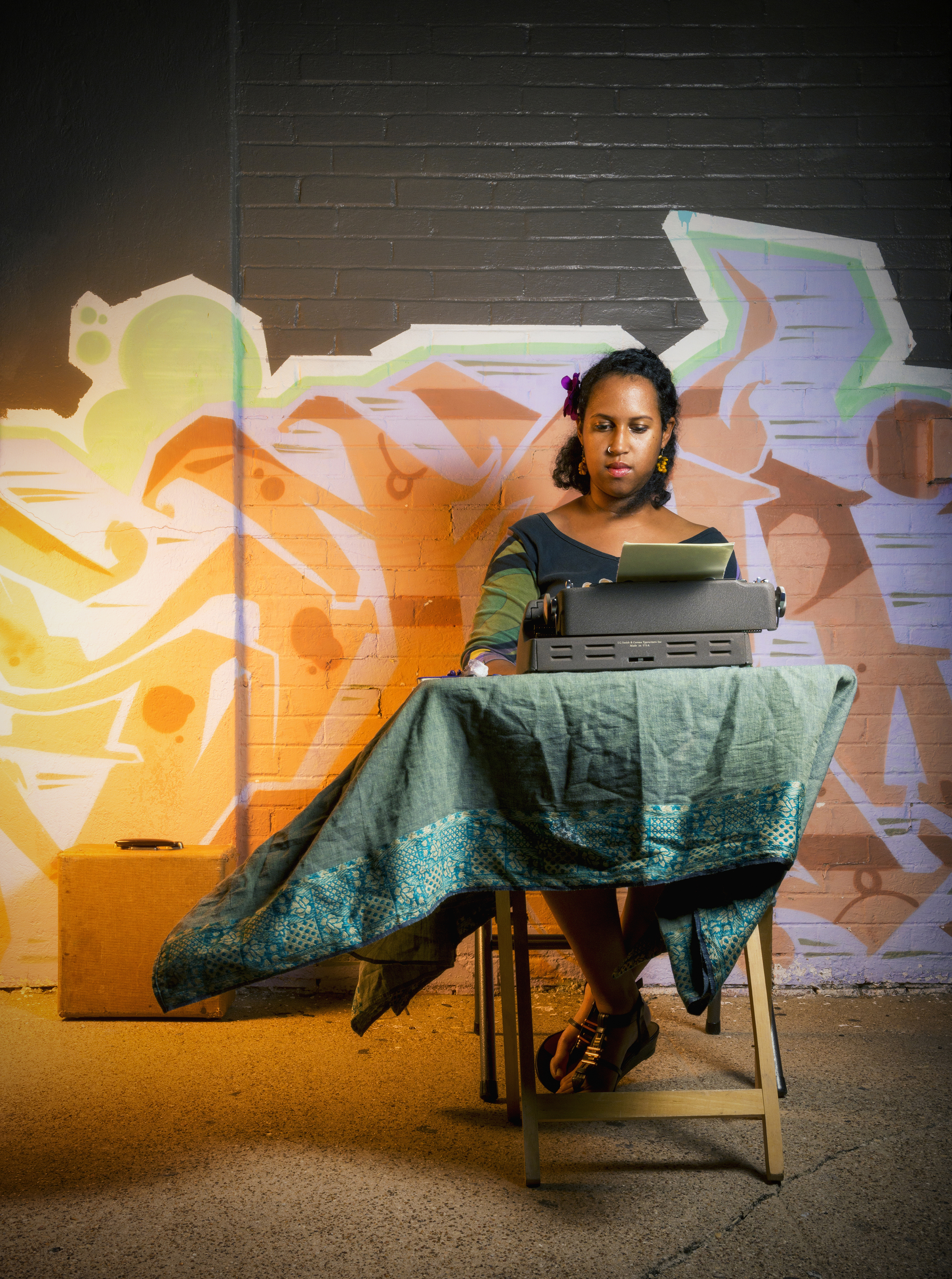  Fatima Hirsi types a poem on Lower Greenville Avenue in Dallas, TX.  After meeting a street poet in Austin, TX, Hirsi began spontaneously typing poems for passersby in Dallas.  Her donation-based service asked only that a patron offer a single perso