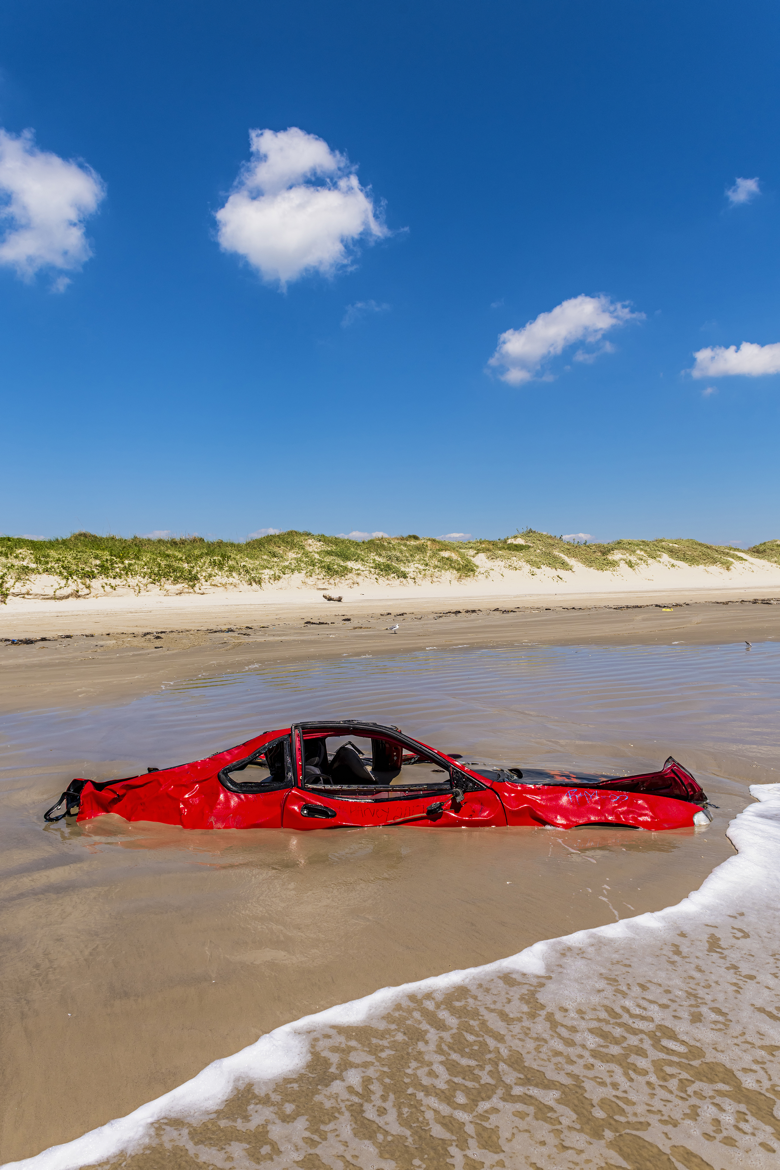  Far from any road, a surf-battered sedan is slowly consumed by Cinnamon Shore on Mustang Island near Port Aransas, TX.  Wreckage from Hurricane Harvey still littered the Texas coast weeks after the storm abated. 