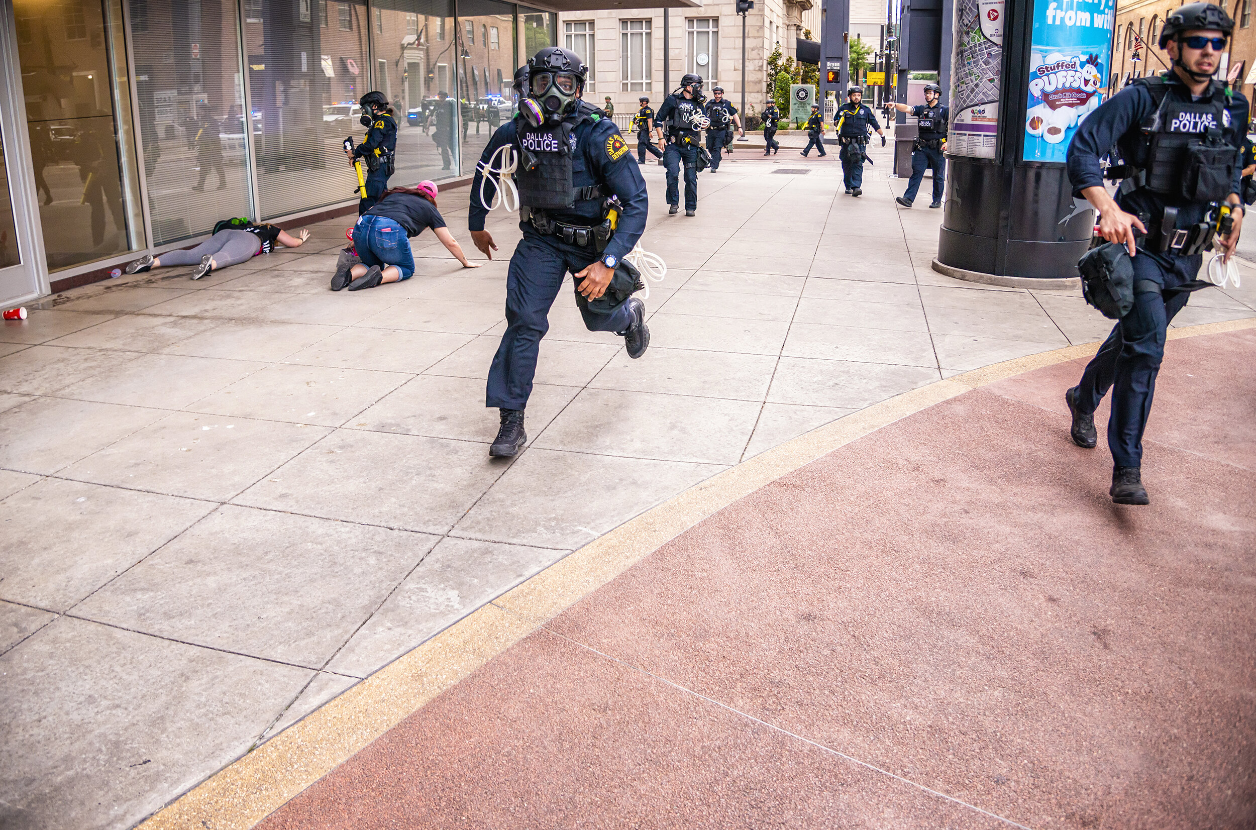  Twelve minutes past curfew, police rush anti-police brutality protesters in downtown Dallas, TX on May 31, 2020.  After previous protests in Dallas saw an aggressive police response followed by incidents of looting, violence and vandalism, a 7 p.m. 