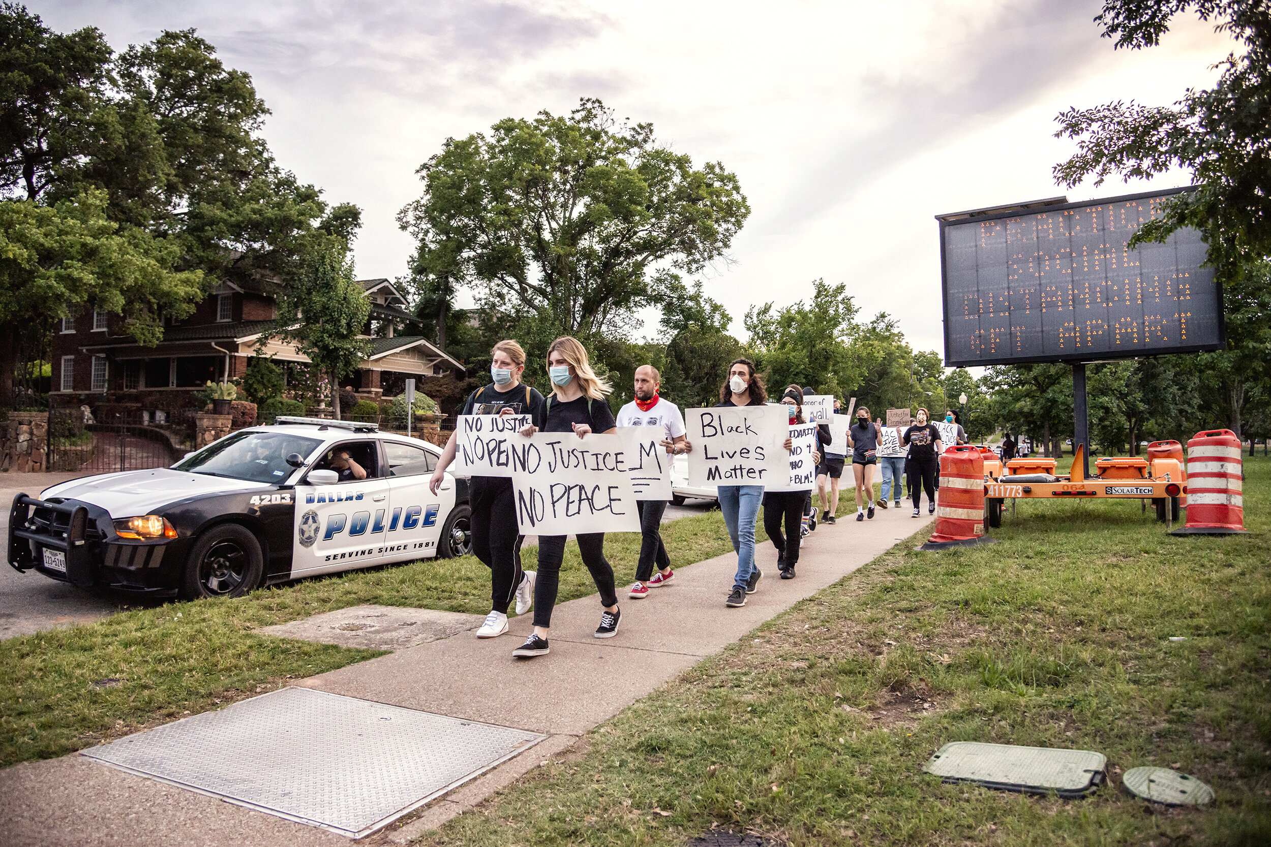  Protesters march through Lake Cliff Park in the Oak Cliff neighborhood of Dallas, TX on June 1, 2020.   Marchers publicly protested systemic racism despite state-wide calls to self-isolate during the fourth month of the COVID-19 pandemic. 