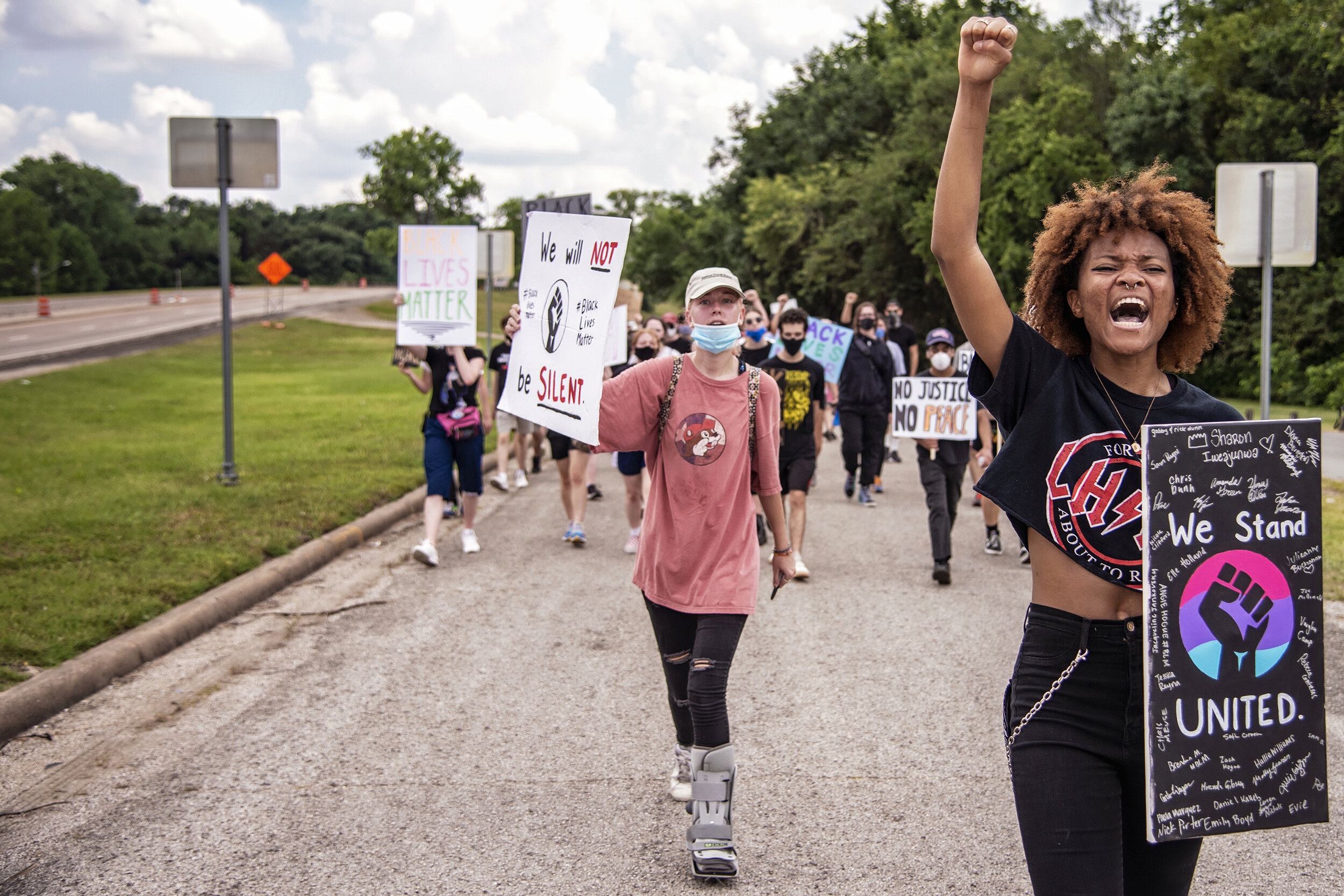  Protesters against racism and police brutality march near White Rock Lake in Dallas, TX on June 2, 2020.   The protest was organized by Emily Boyd (center) and Sharon Iweajunwa (right), both 2019 graduates of Lake Highlands High School.  “Our goal w