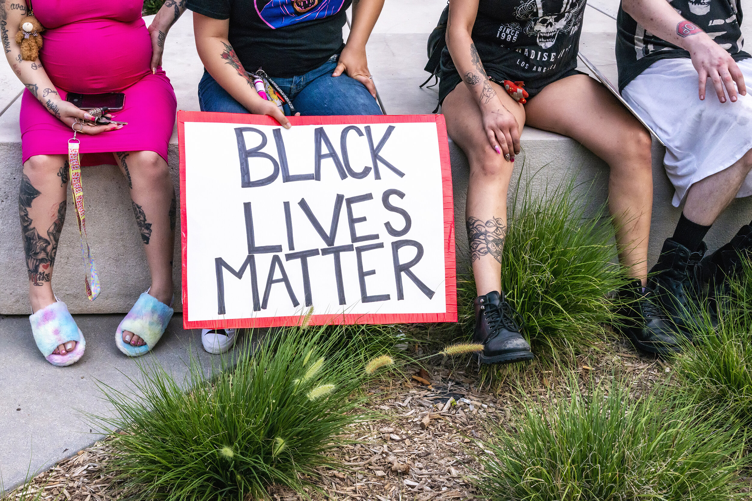  Protest marchers rest at Pacific Plaza in Dallas, TX on June 6, 2020.  Temperatures hit 97 degrees with some protesters collapsing from heat exhaustion. The woman at left said she was inclined to protest in the heat despite being eight months pregna